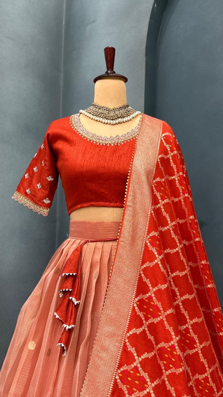 Light orange traditional outfit with a blouse and saree on a mannequin against a gray background