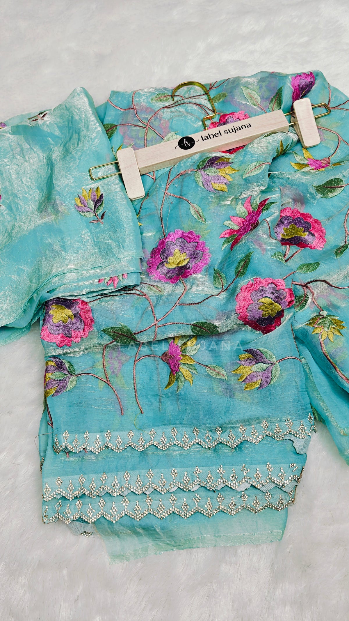 A sky blue embroidery saree with matching embroidery blouse