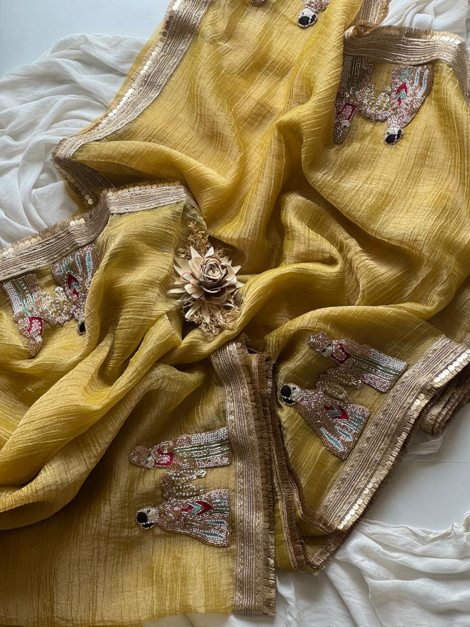 Light Yellow fabric with intricate silver embroidery on a white background