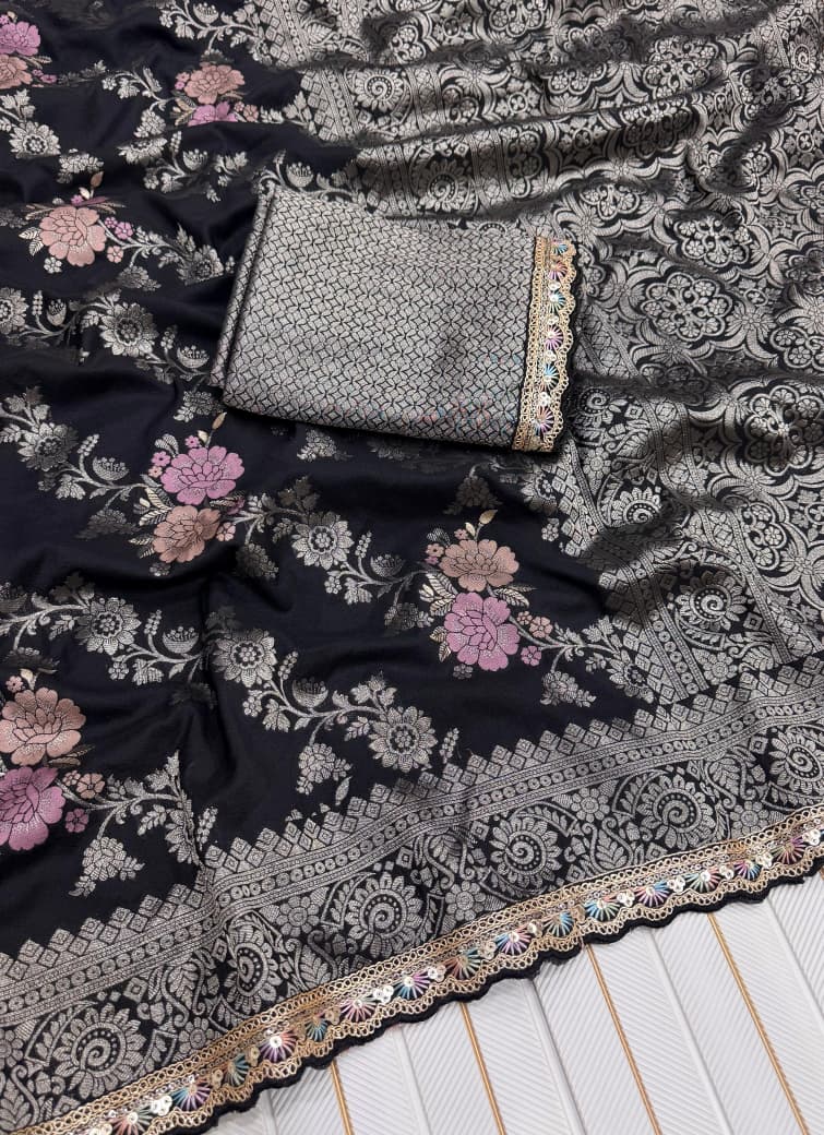 Black floral embroidered fabric with a silver clutch on top