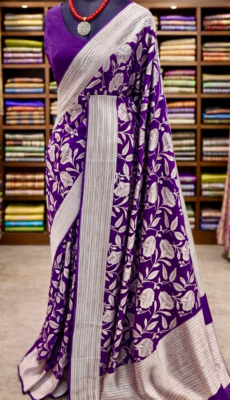 Purple saree with floral pattern displayed in a store setting