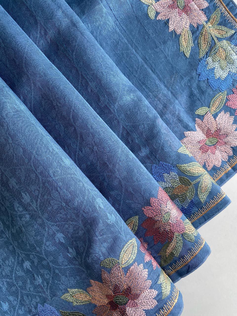 Blue fabric with floral embroidery on a background