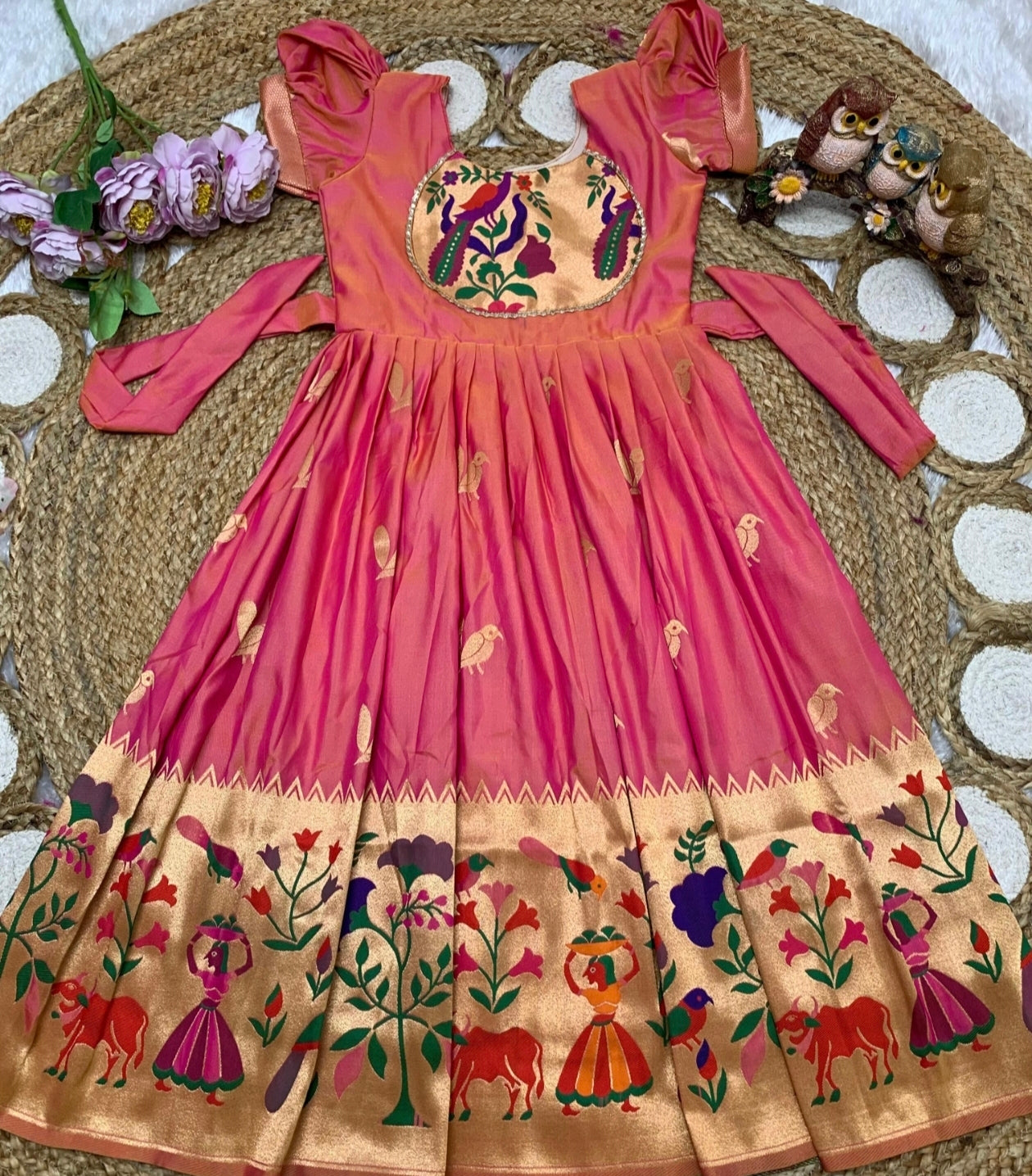 Peach dress with intricate patterns on a textured surface