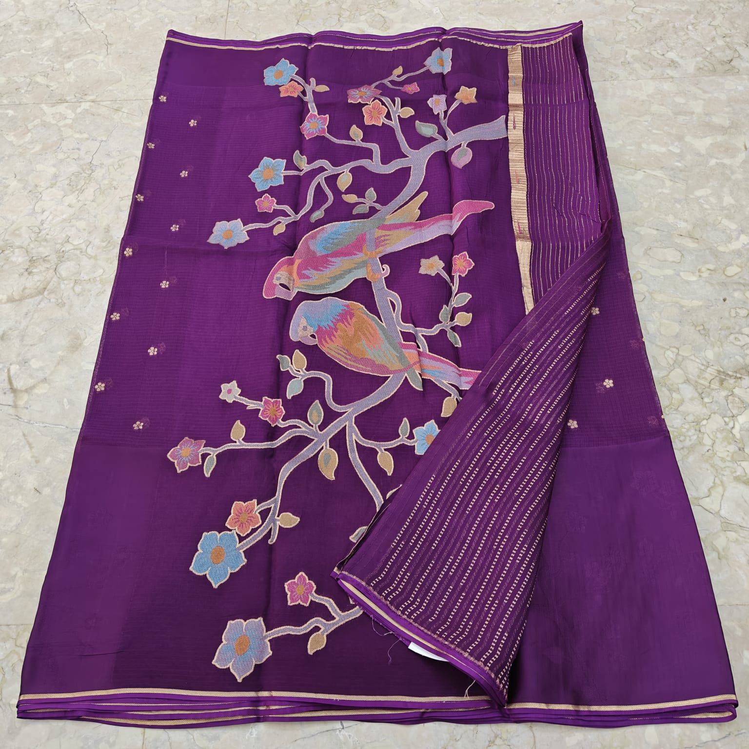 Purple fabric with bird and floral patterns 