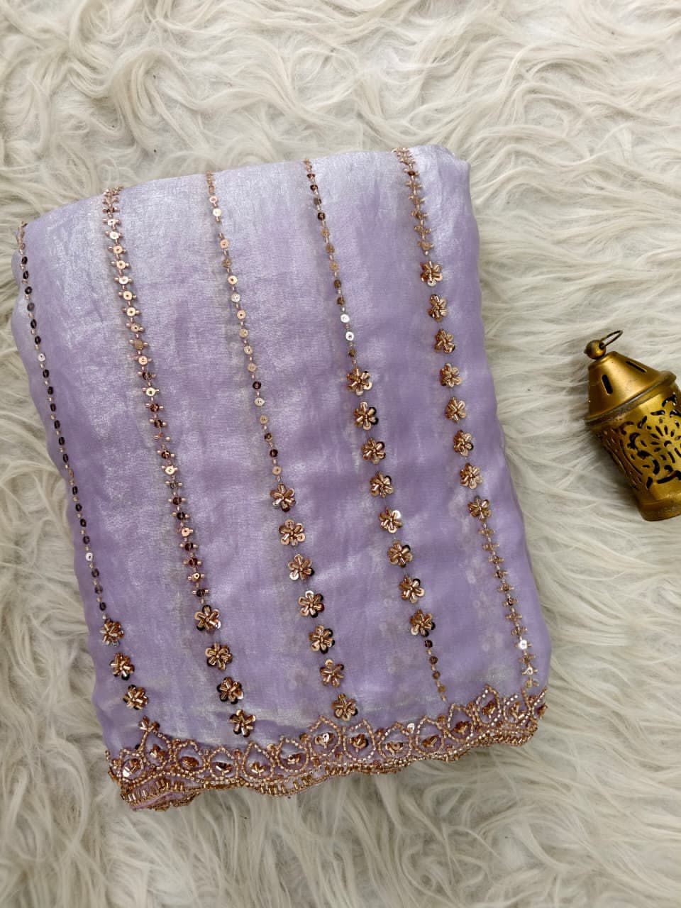 Lavender fabric with gold embroidery on a texture surface