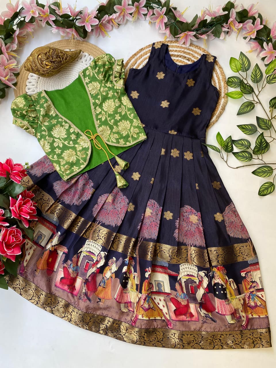 Traditional outfit with a navy blue dress and  jacket on a decorative background with flowers and leaves.