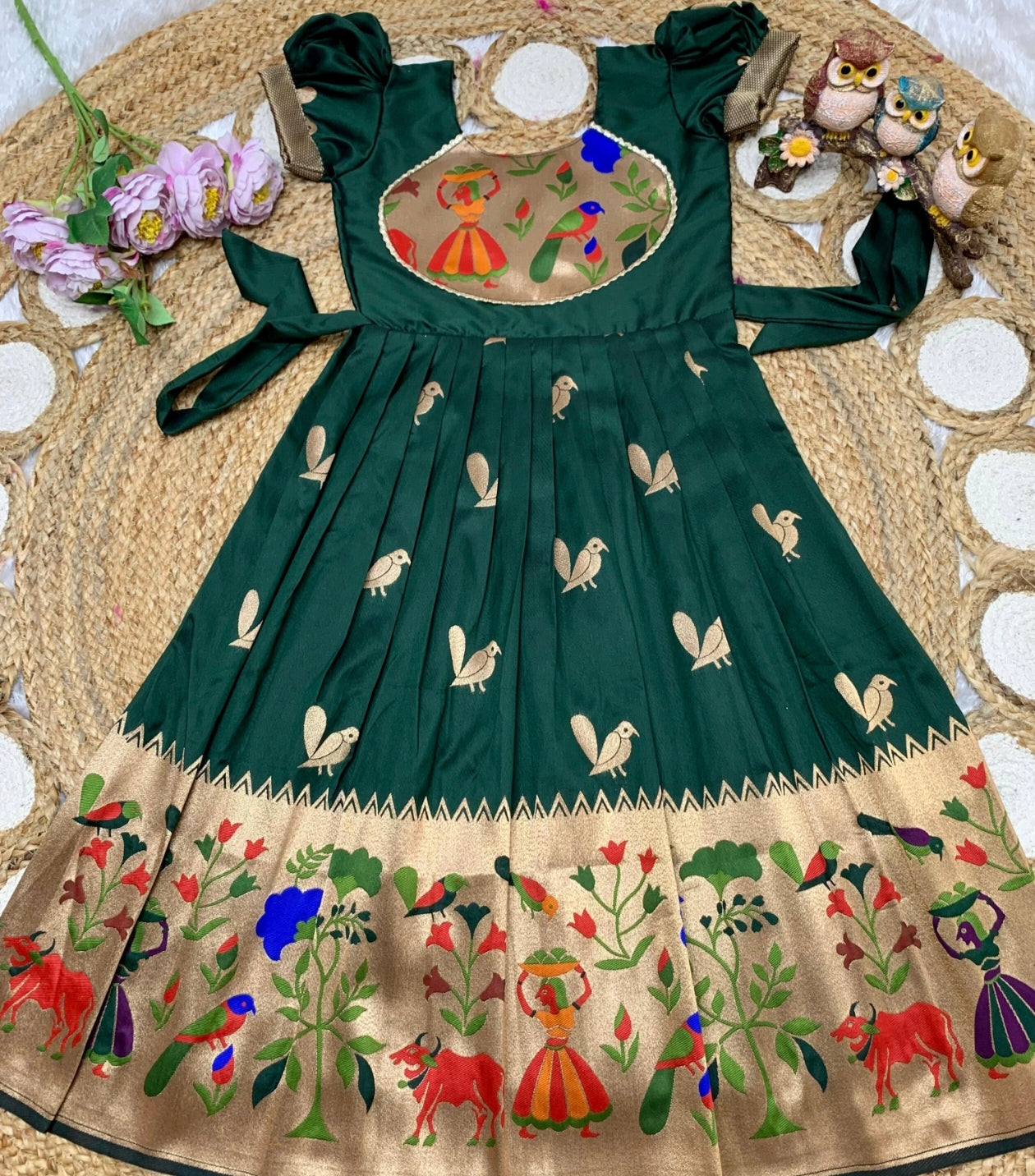 Dark Green dress with intricate embroidery on a texture surface