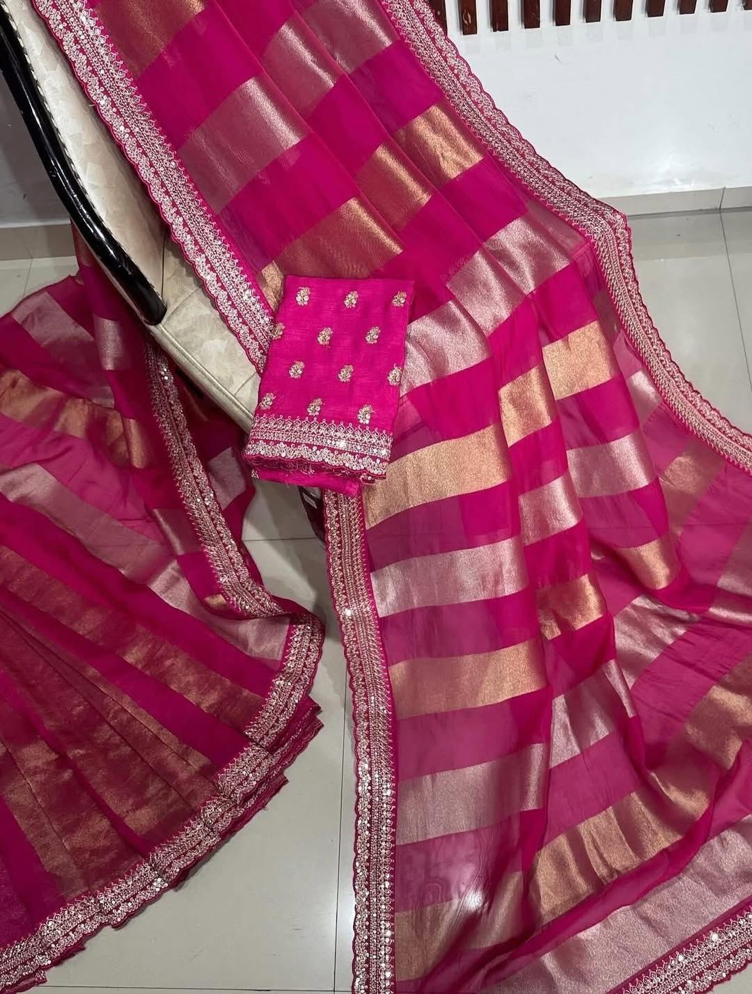 Pink saree with a checks pattern on a white floor