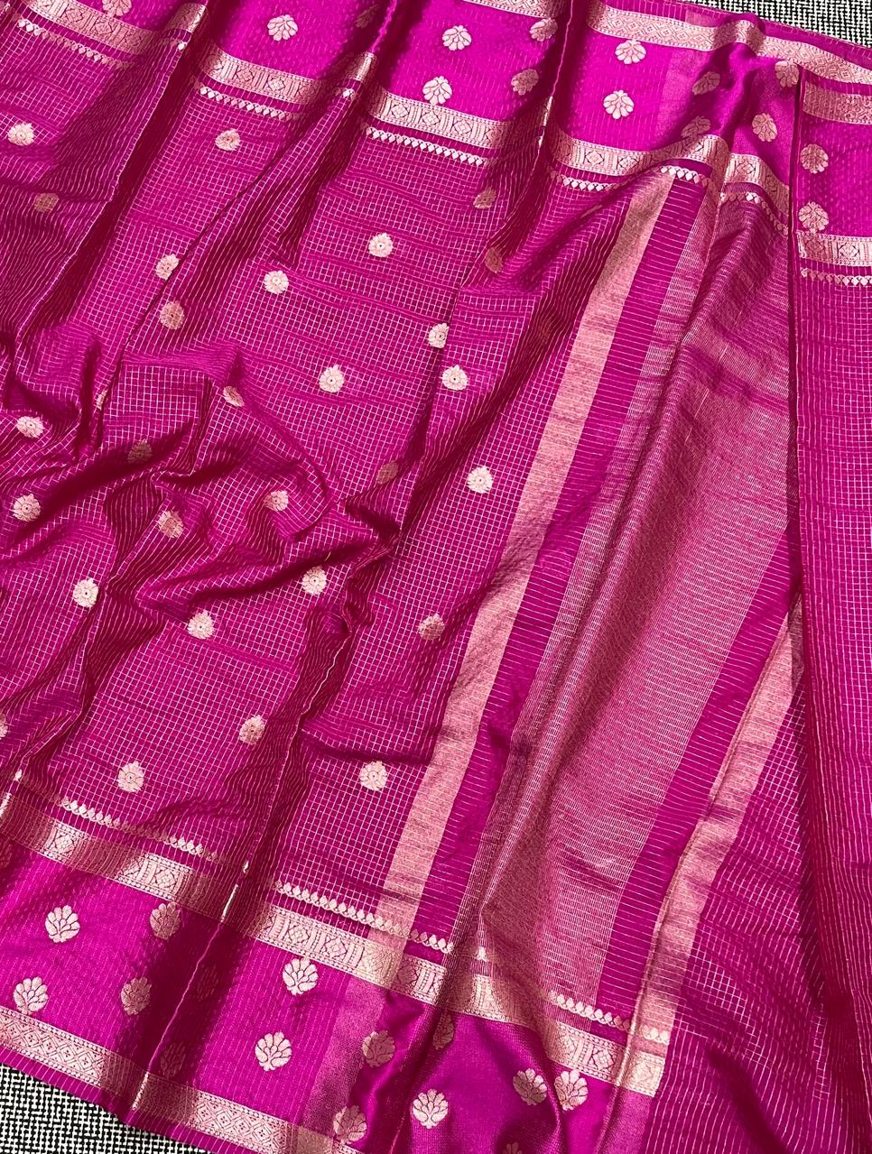 Close-up of a pink saree with white patterns