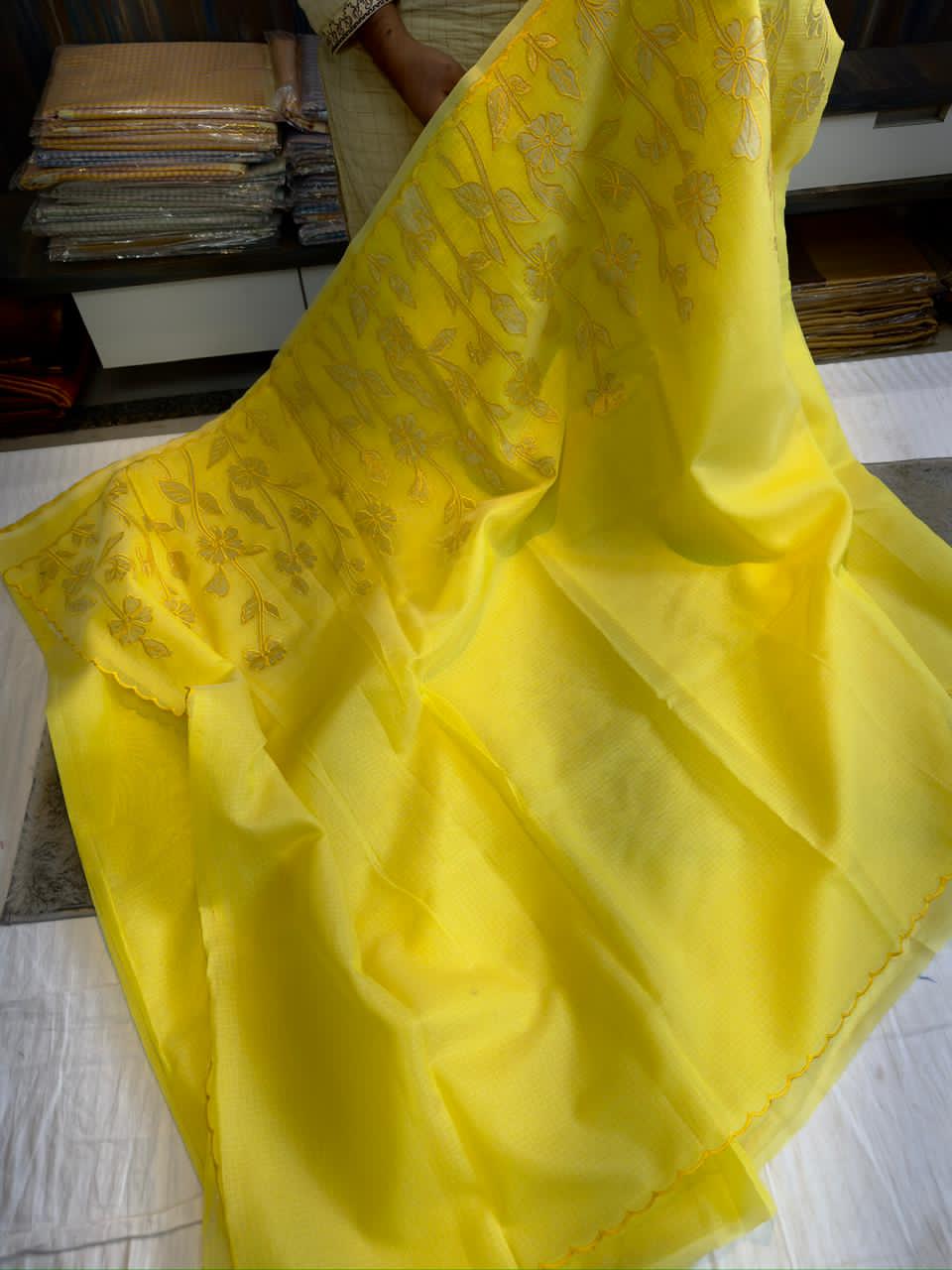 Yellow fabric with gold embroidery patterns 