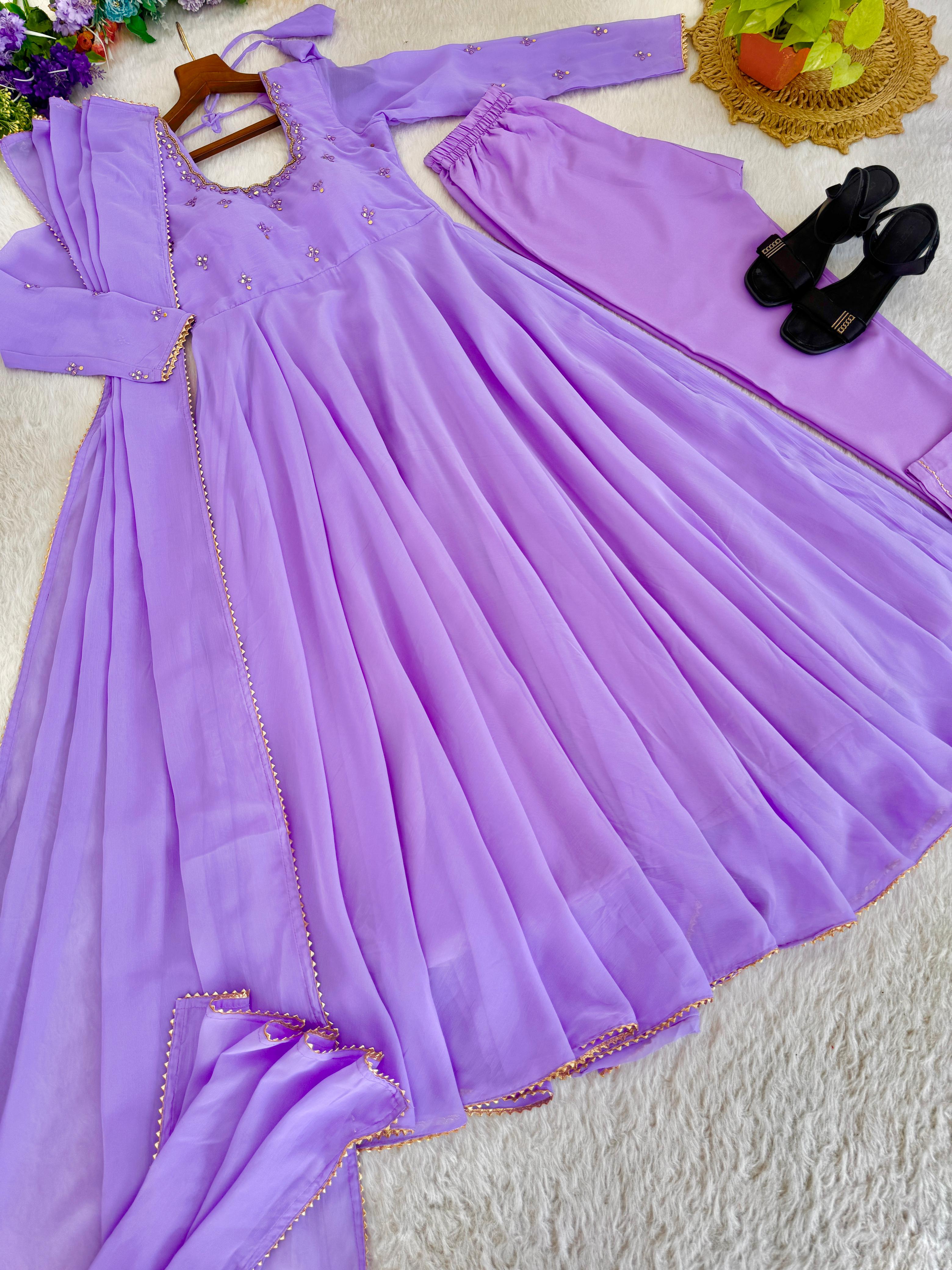 Purple dress with matching pants and shoes on a texture surface
