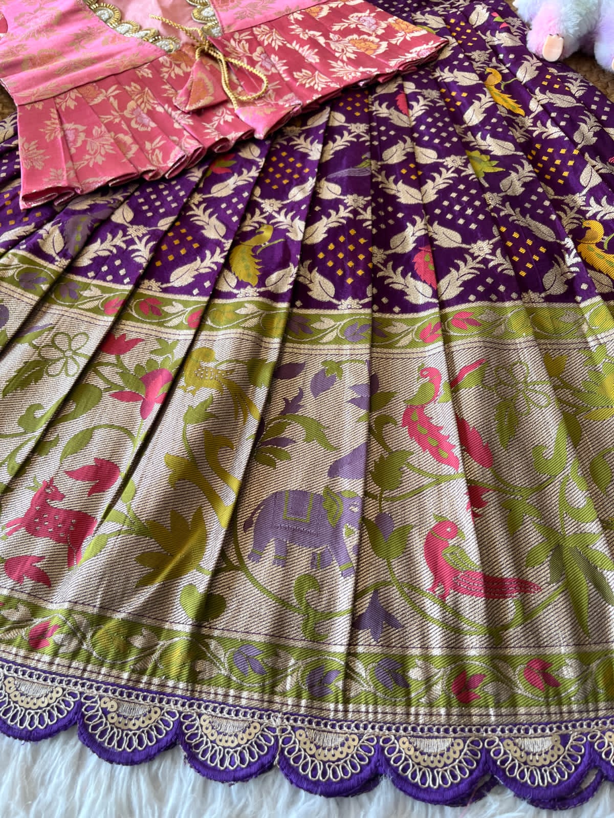 Colorful purple dress with patterns on a plain background