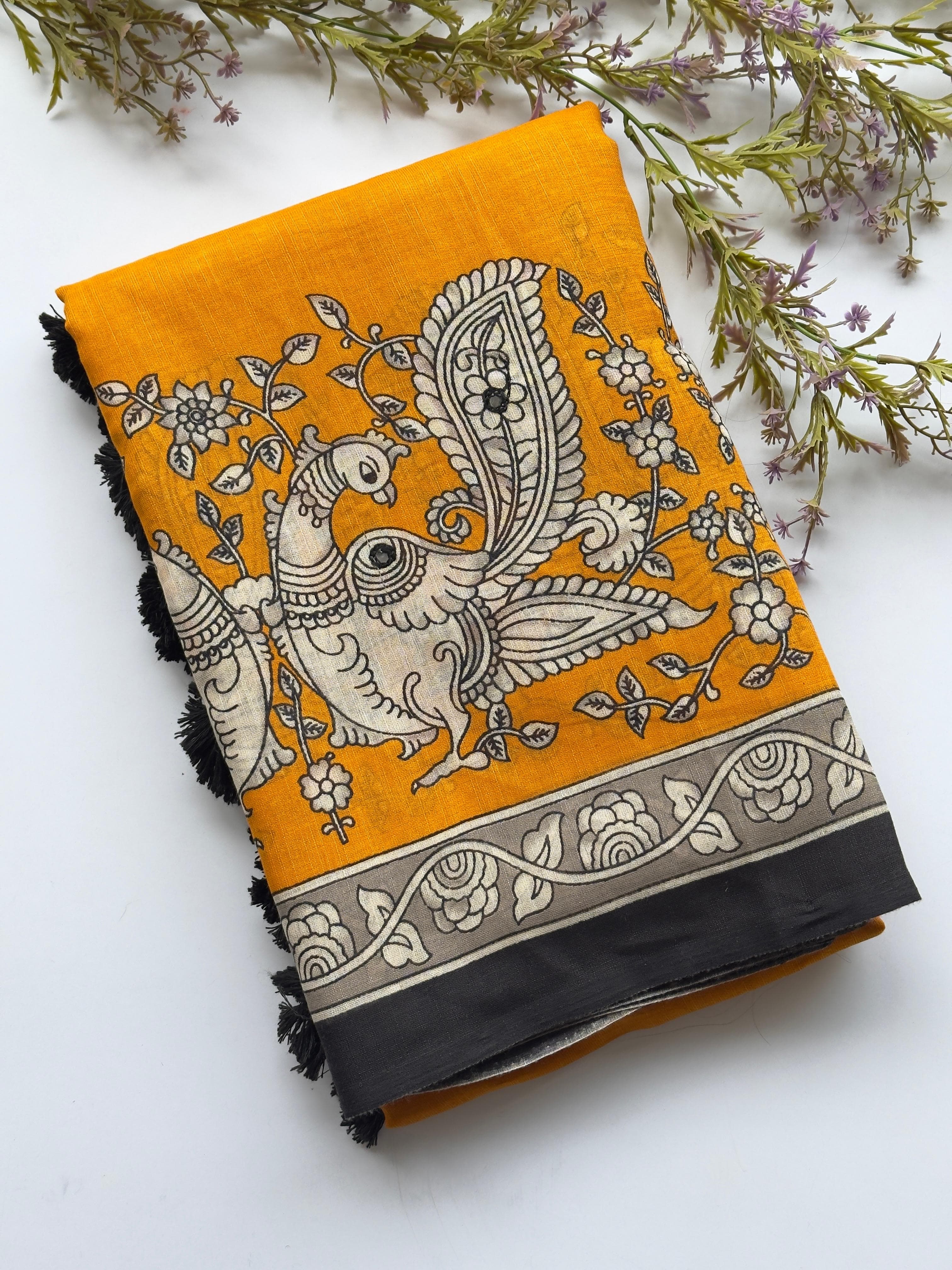Yellow fabric with black and white floral and bird pattern on a white background