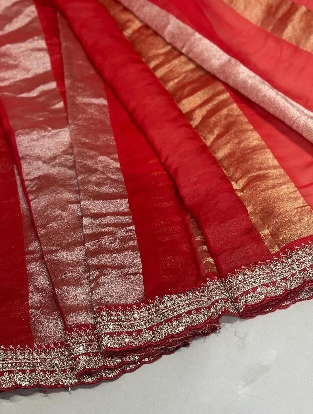 Red fabric with gold and silver stripes on a white background