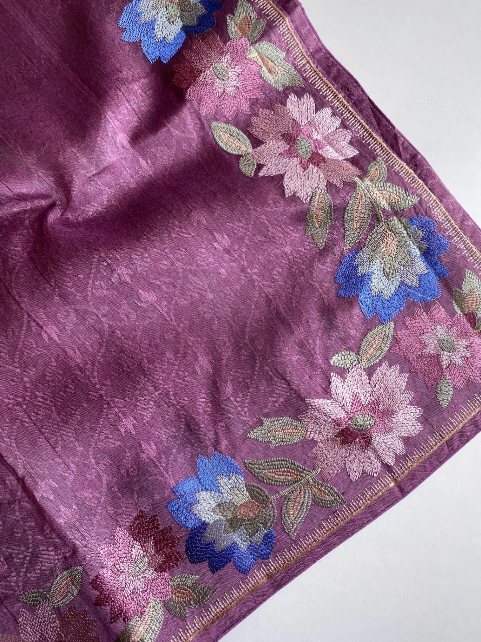 Purple fabric with floral embroidery on a background