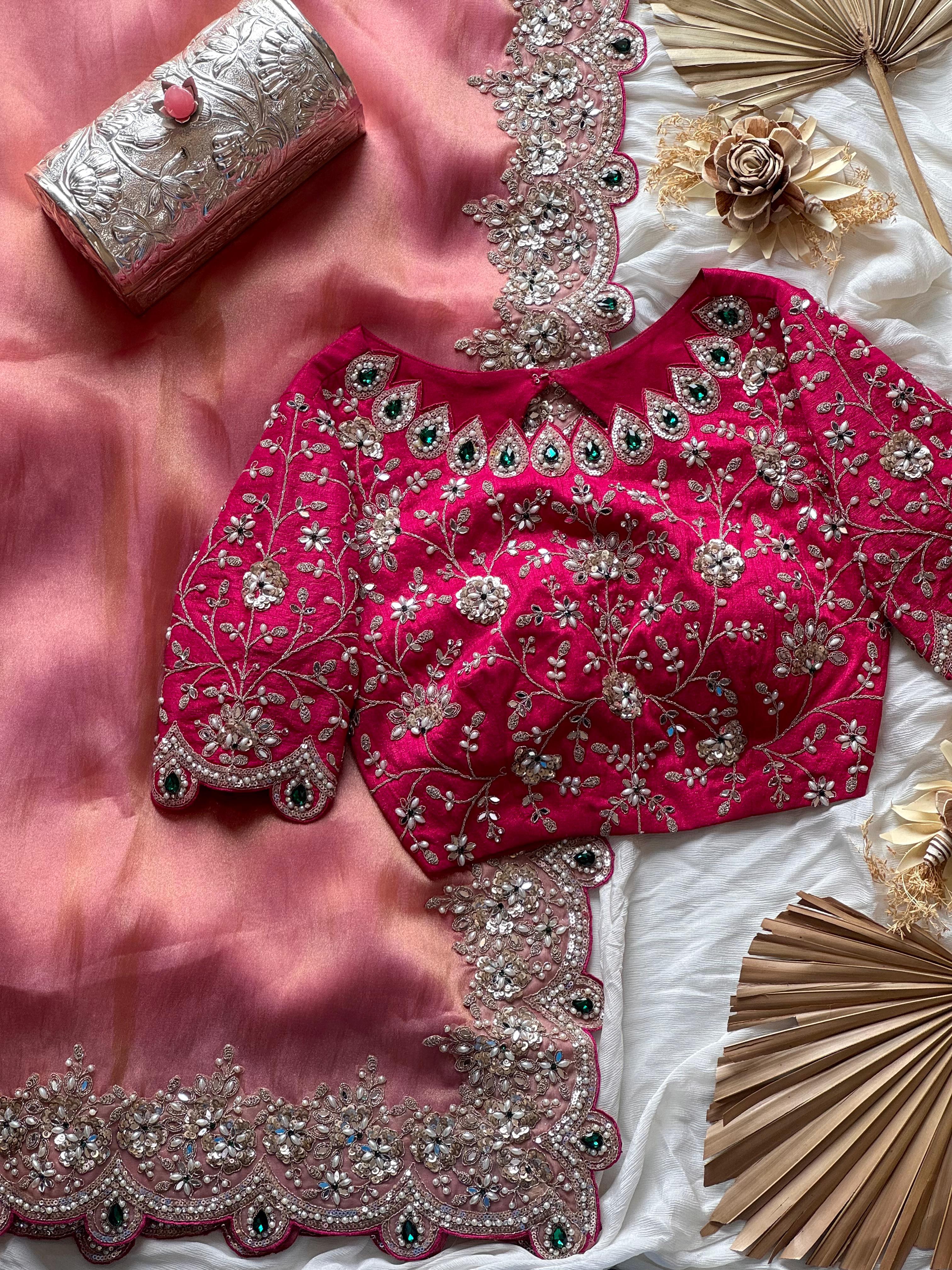 Onion Pink embroidered blouse with silver detailing on a white fabric background