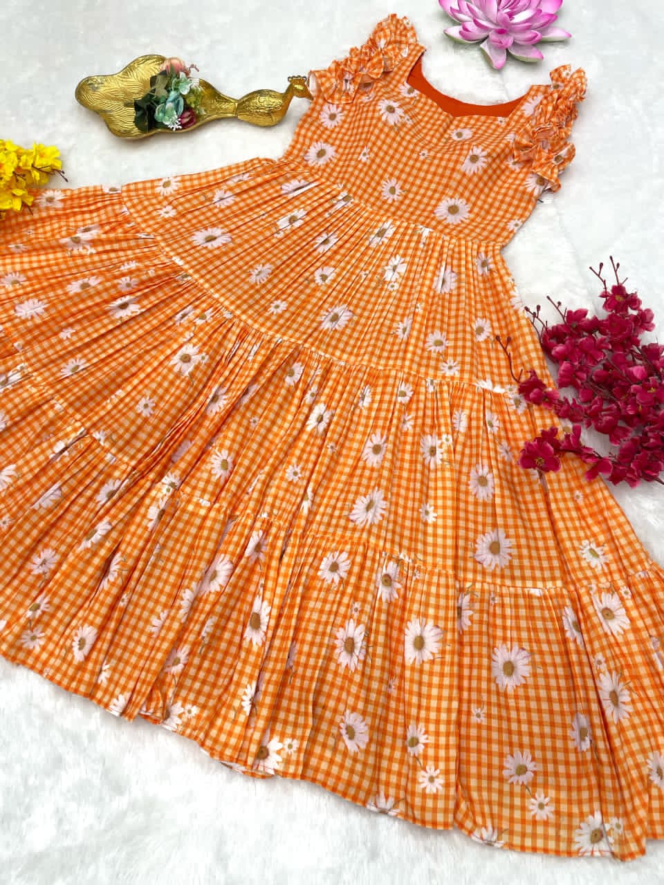 Orange checkered dress with floral patterns on a white background