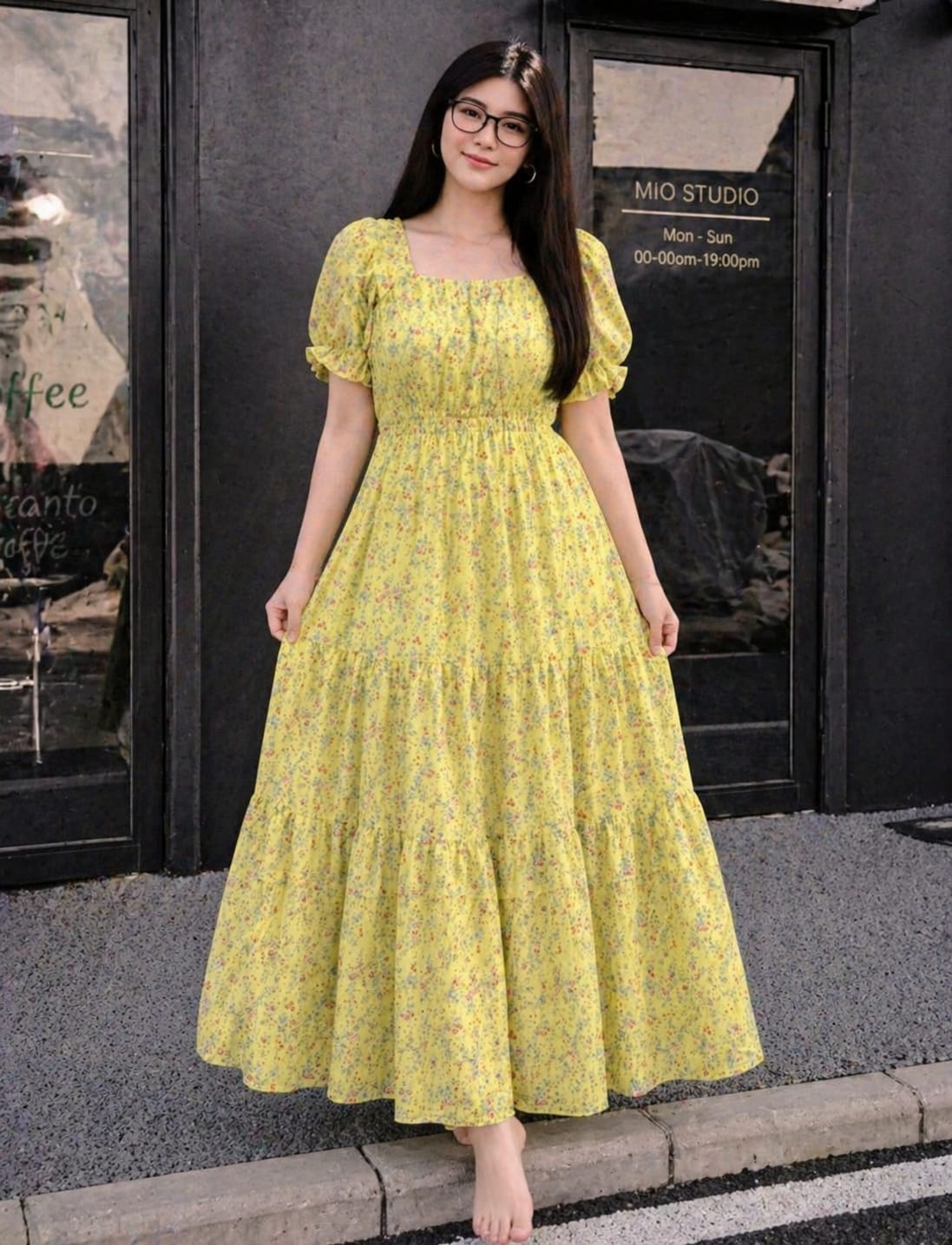 Woman wearing a yellow floral dress standing in front of a store entrance.