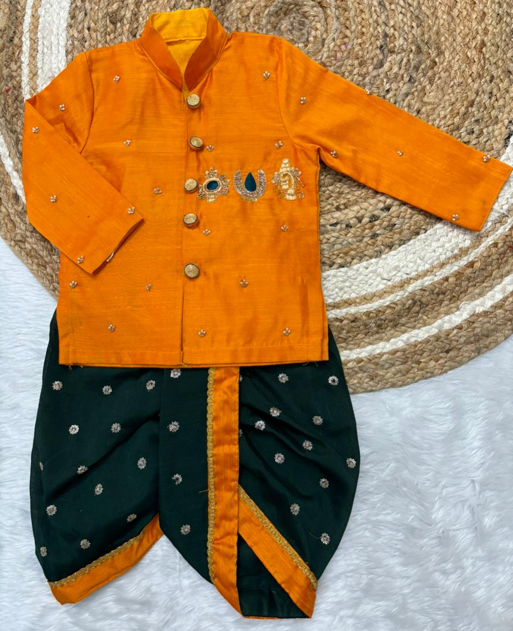Traditional orange and bottle green outfit with intricate designs