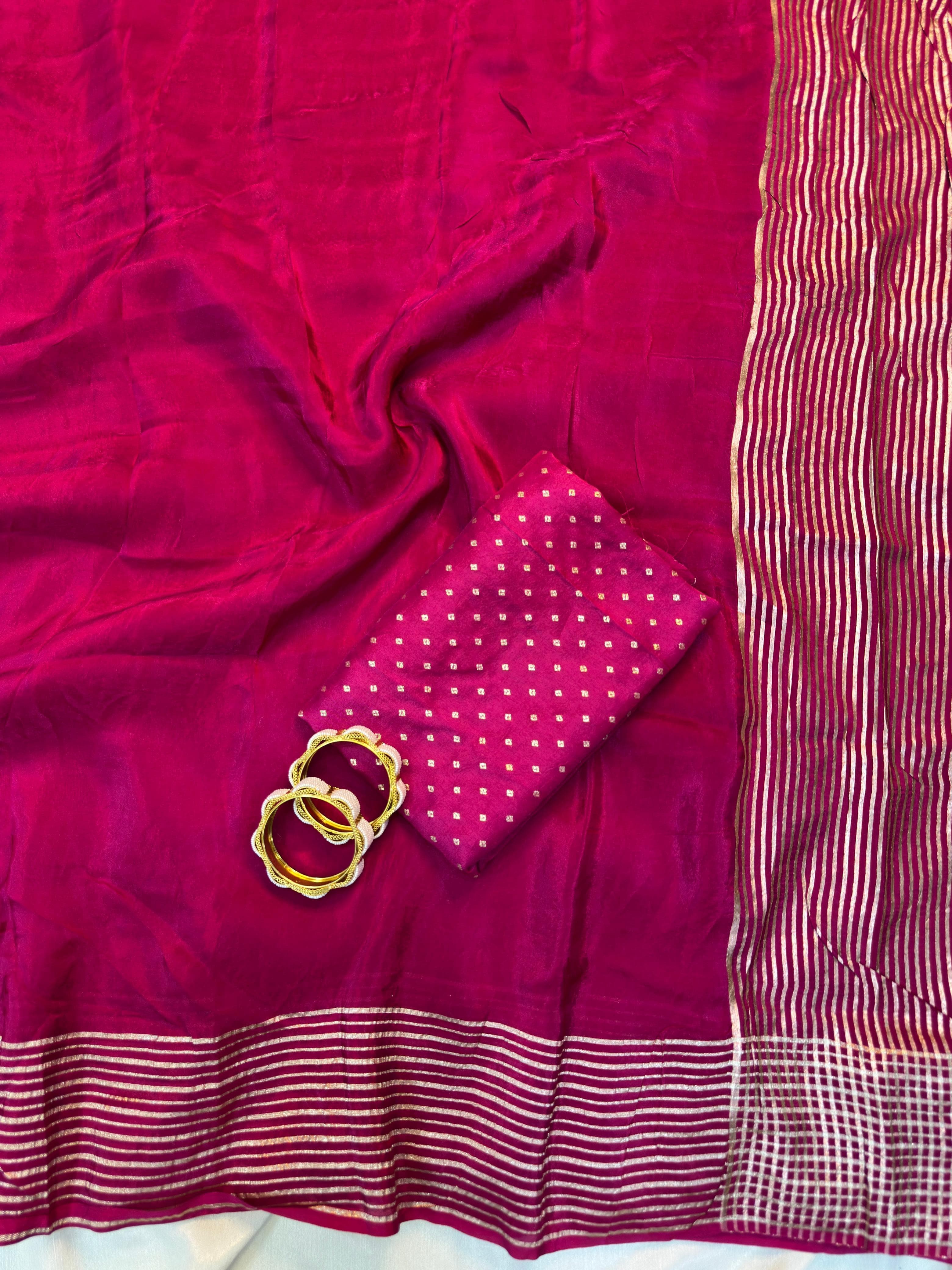 Pink saree with gold ring and white border on a white background