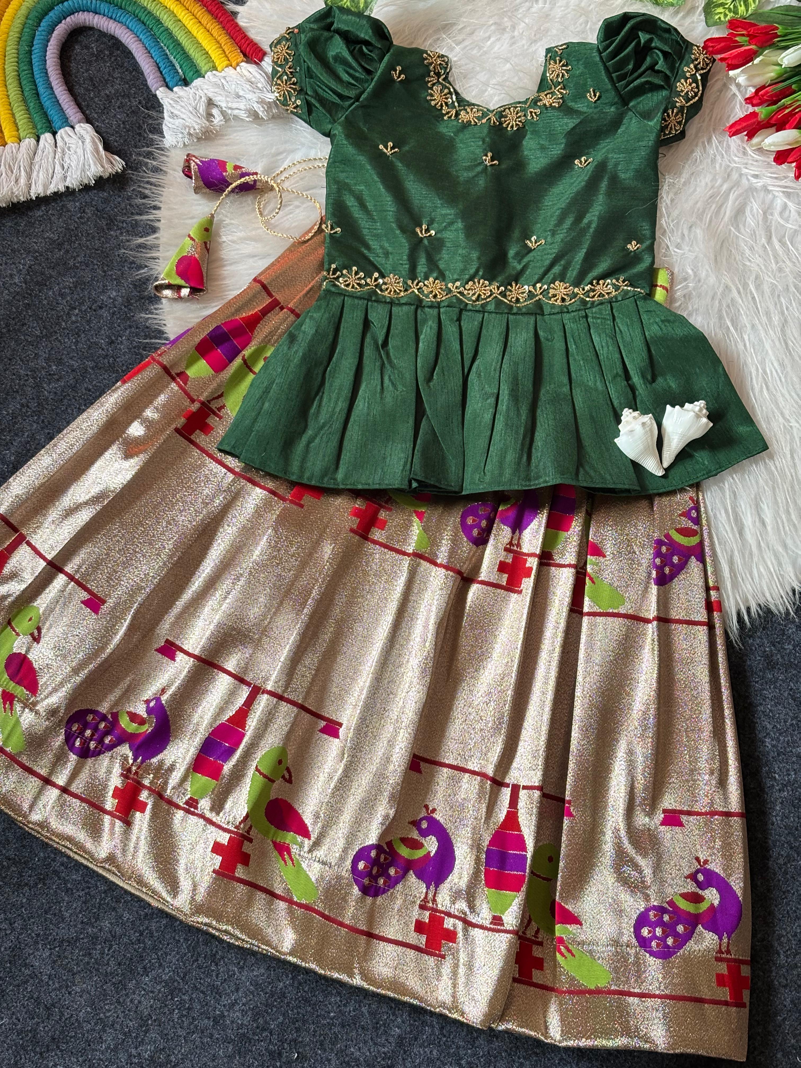 Dark Green embroidered top and  skirt with colorful patterns on a dark surface.