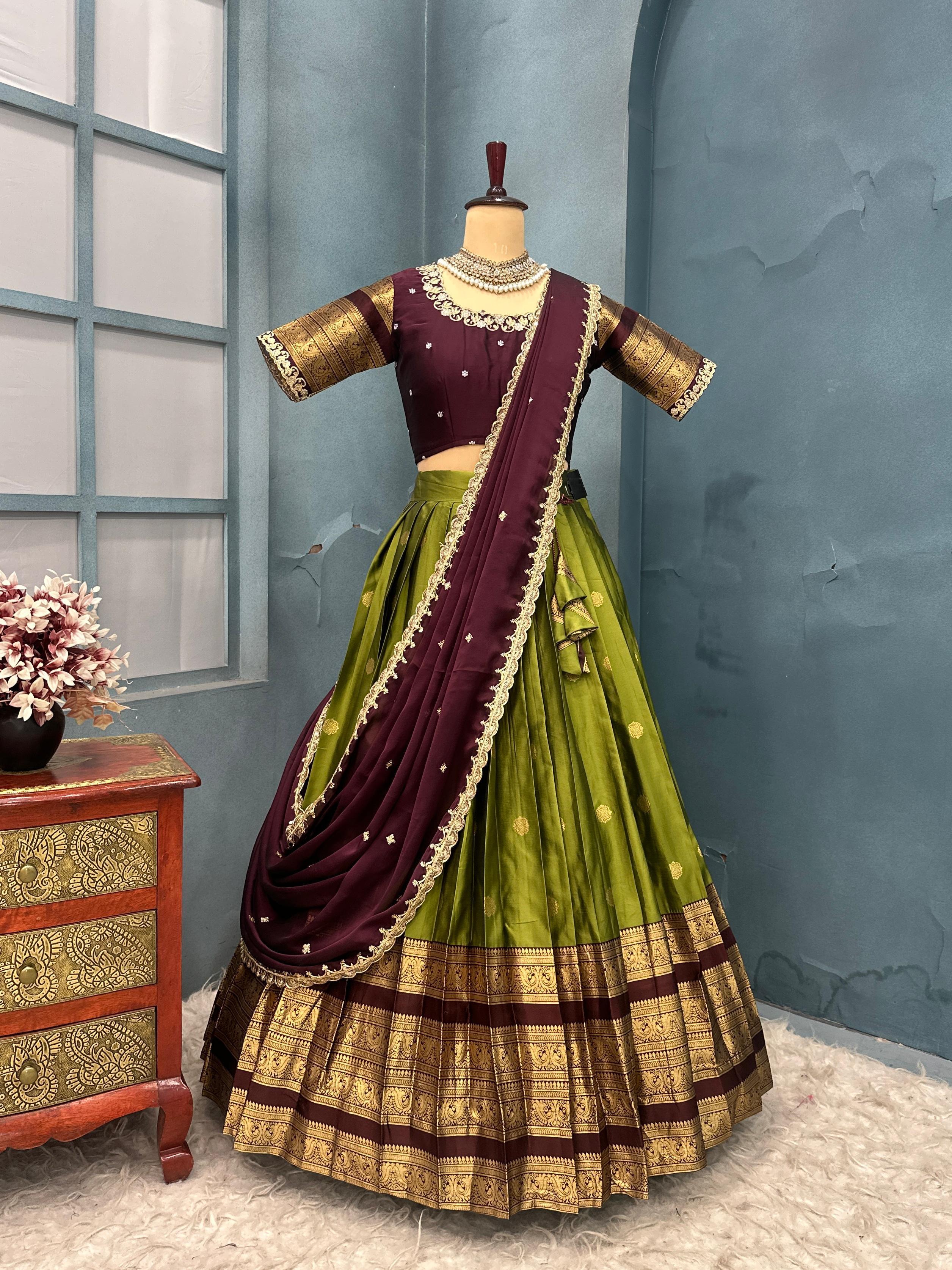 Olive Green and purple traditional outfit on a mannequin against a blue wall.