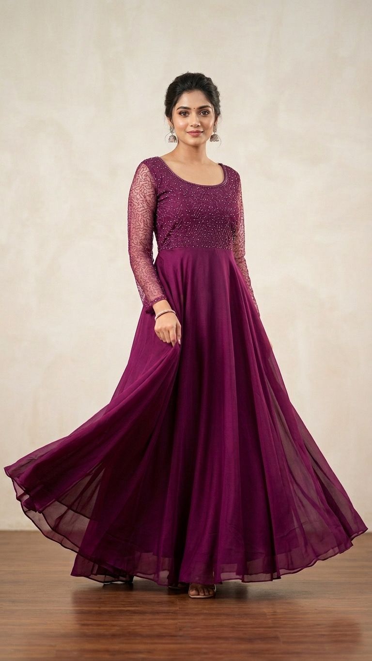 Woman wearing a long magenta dress with a plain background