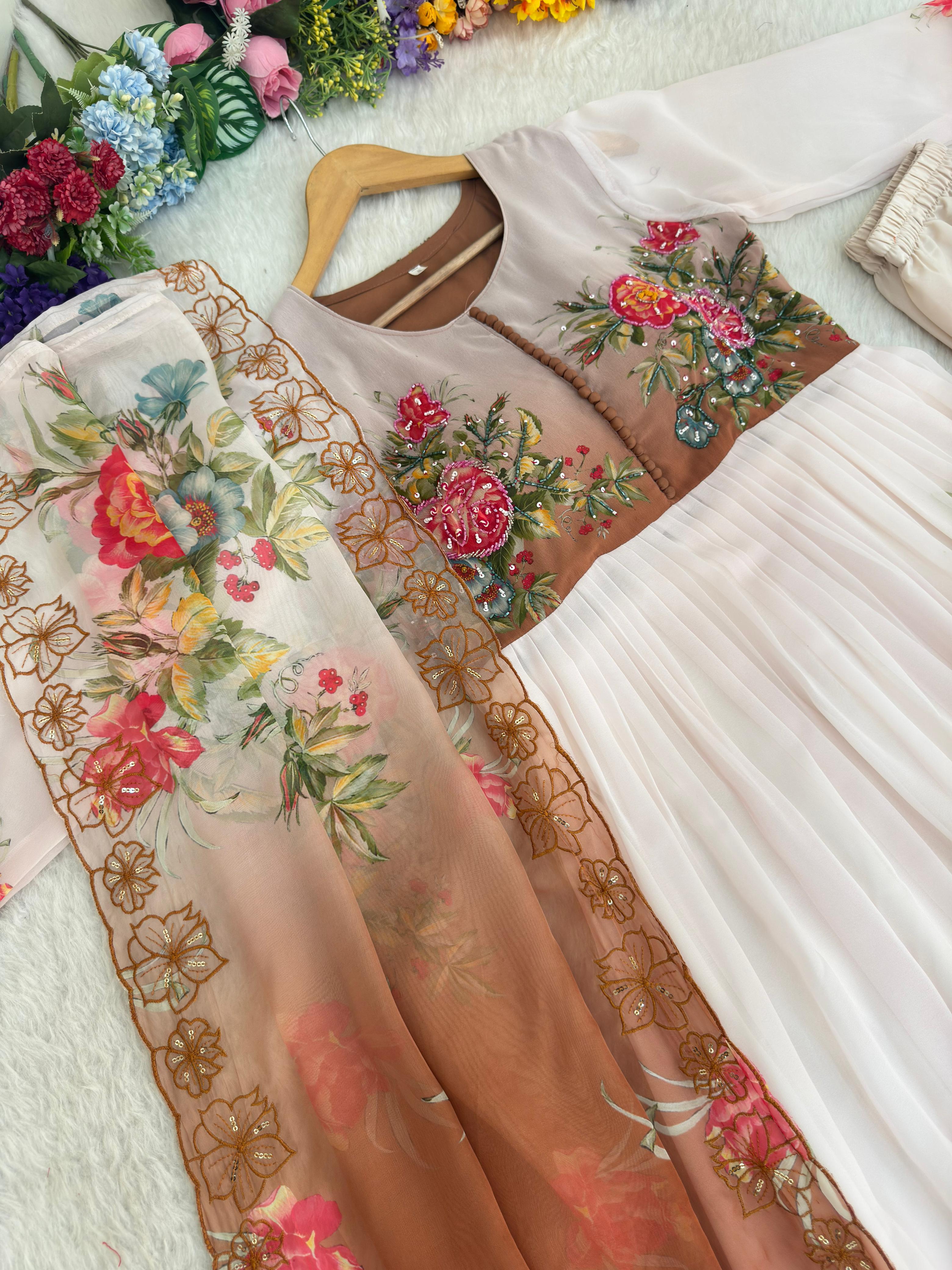White and brown Embroidered dress with floral patterns on a textured surface with flowers in the background