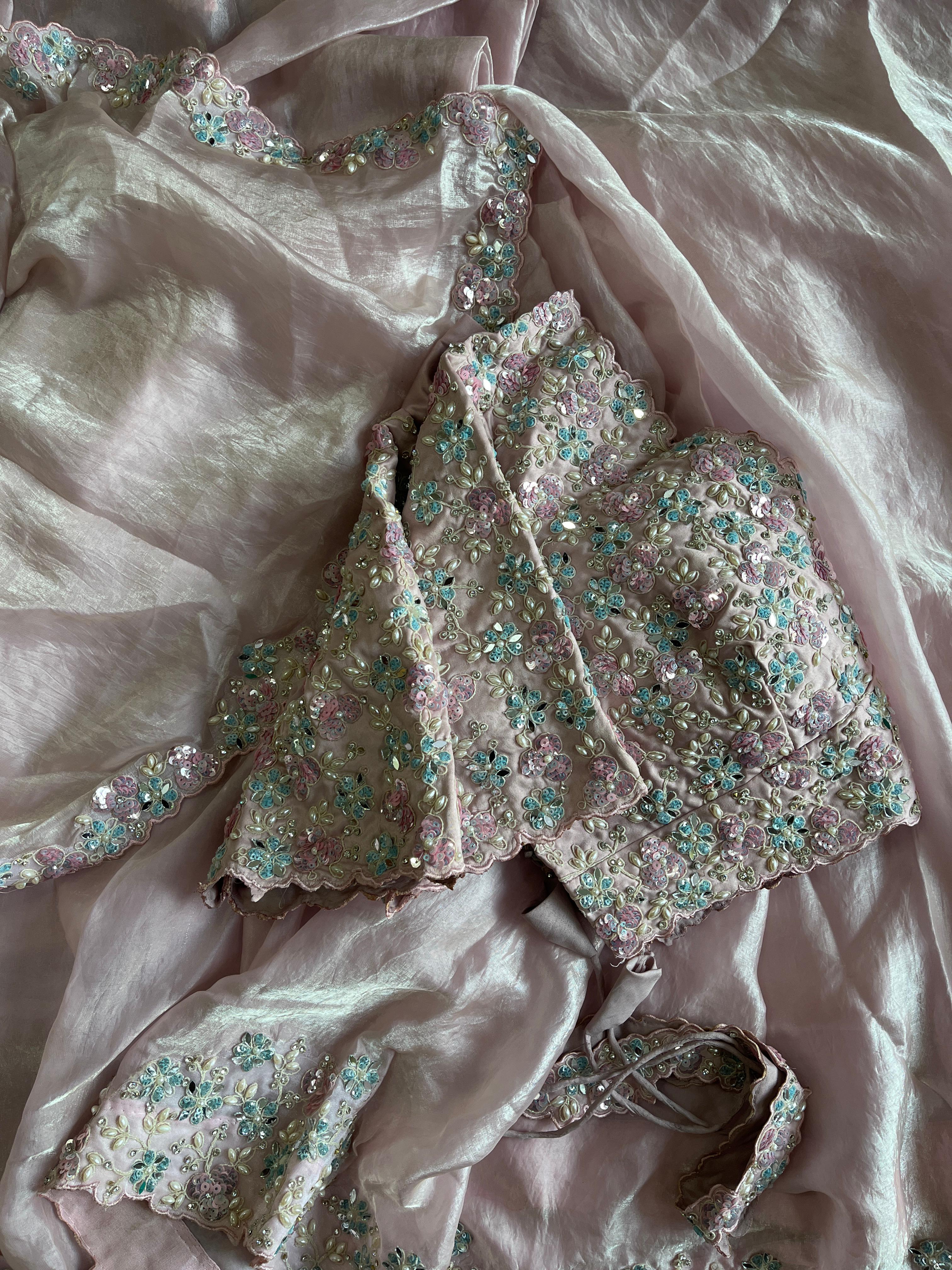 Embroidered garment on a baby pink fabric background