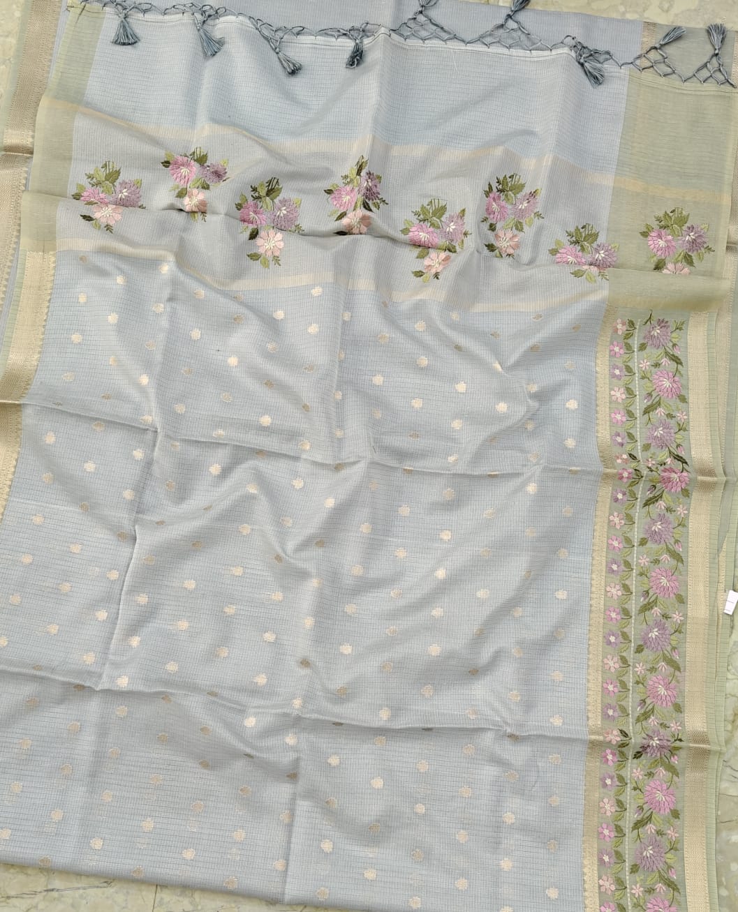 Light blue saree with floral patterns and a border