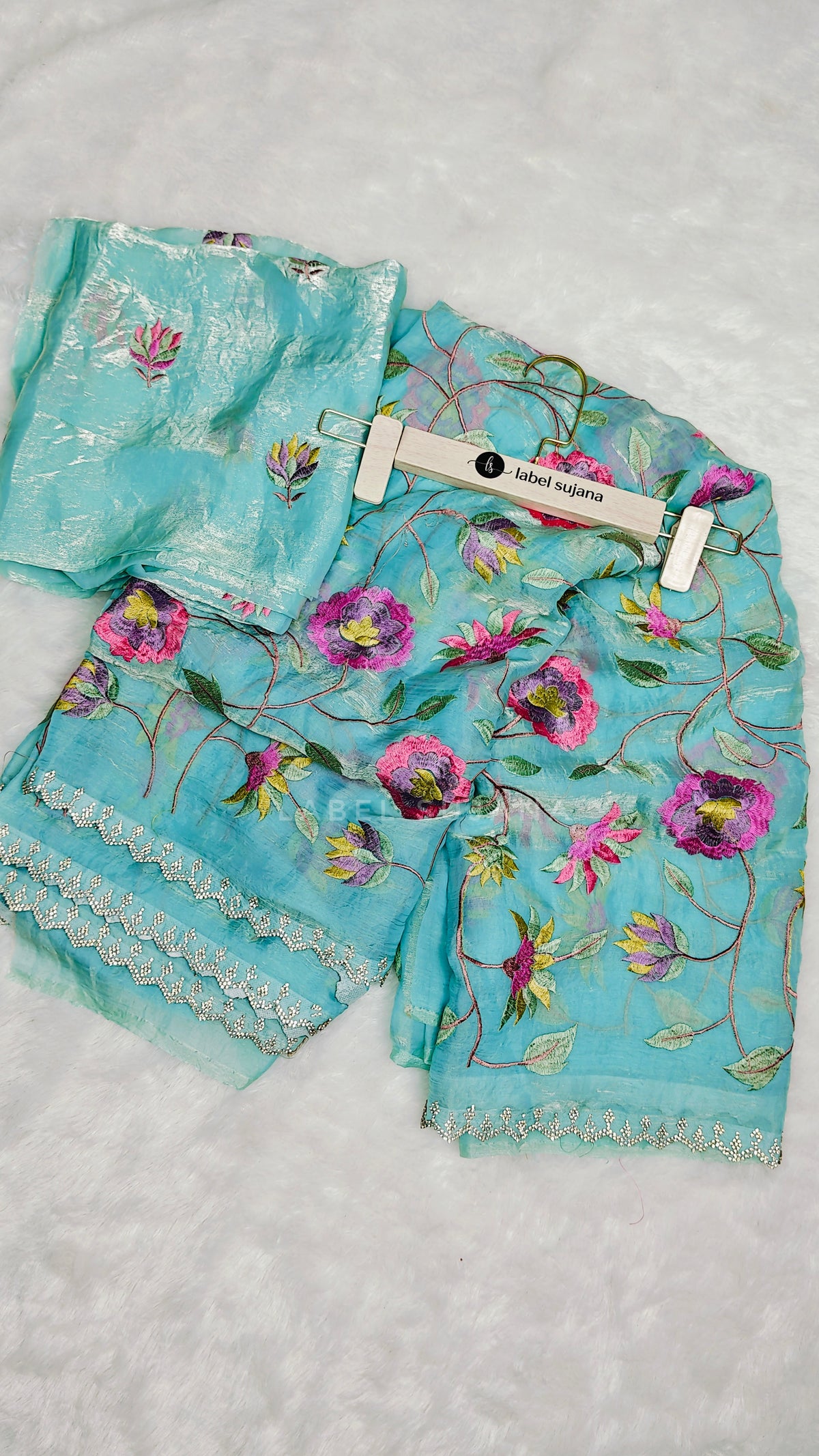 A sky blue embroidery saree with matching embroidery blouse