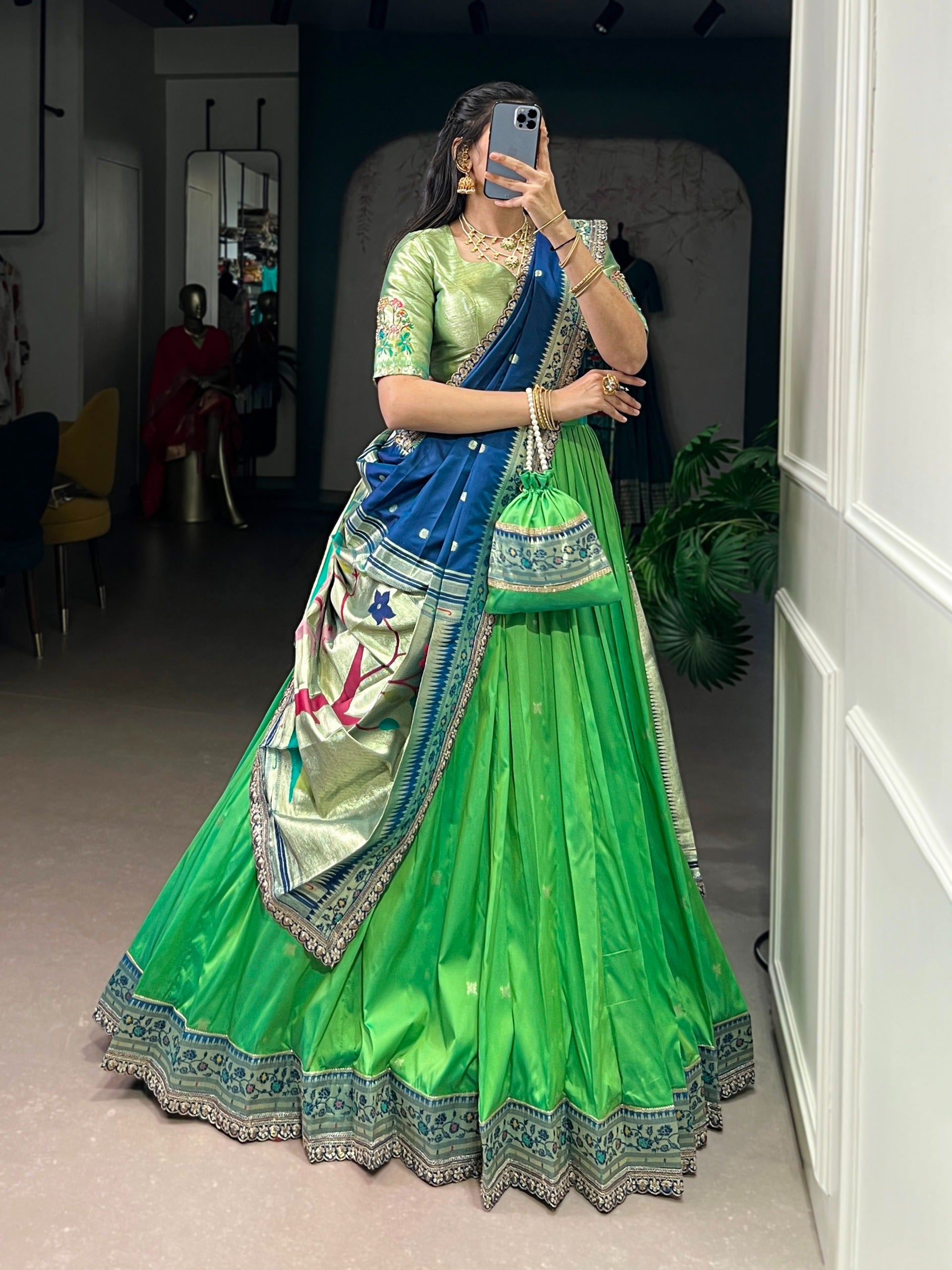 Parrot green traditional outfit taking a mirror selfie.