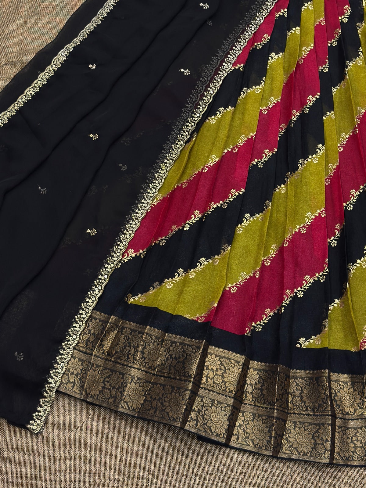 Multicolor saree with gold  border on a textured surface