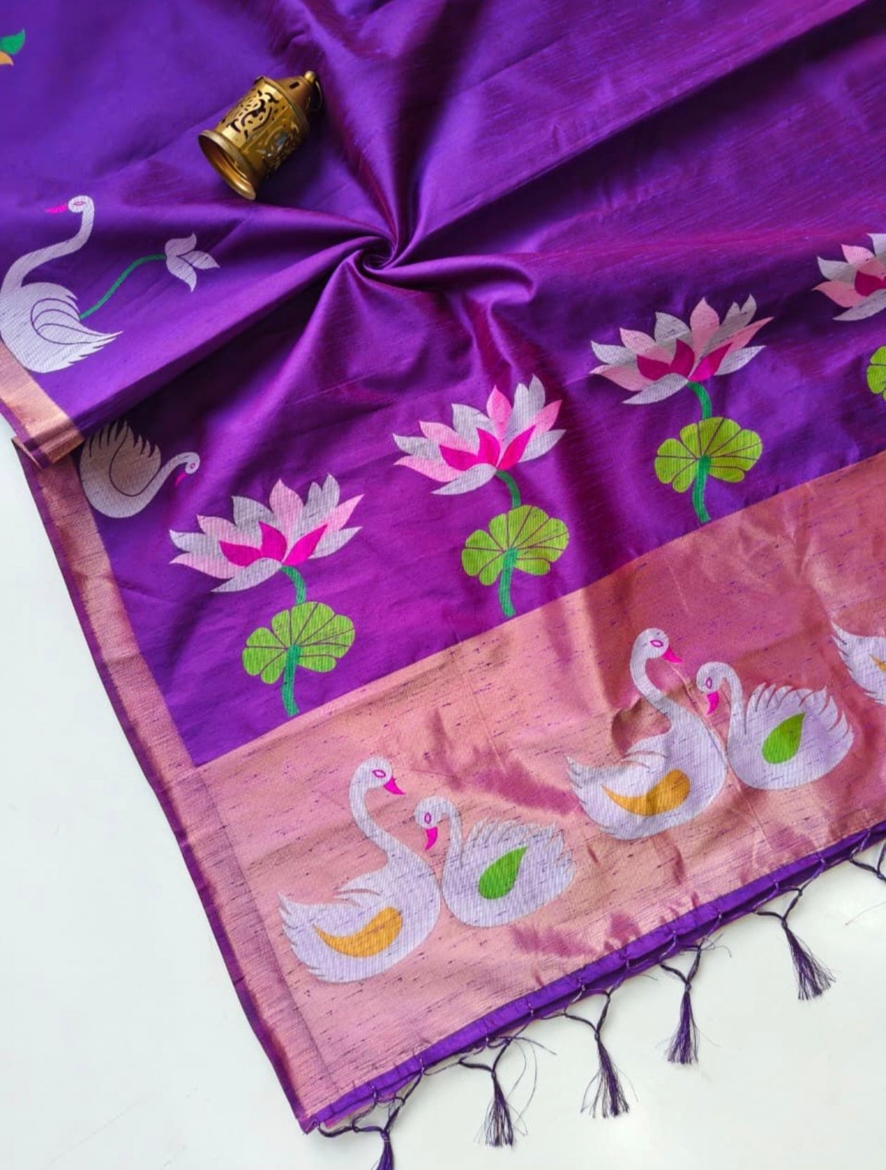 Purple saree with swan and lotus designs on a white background