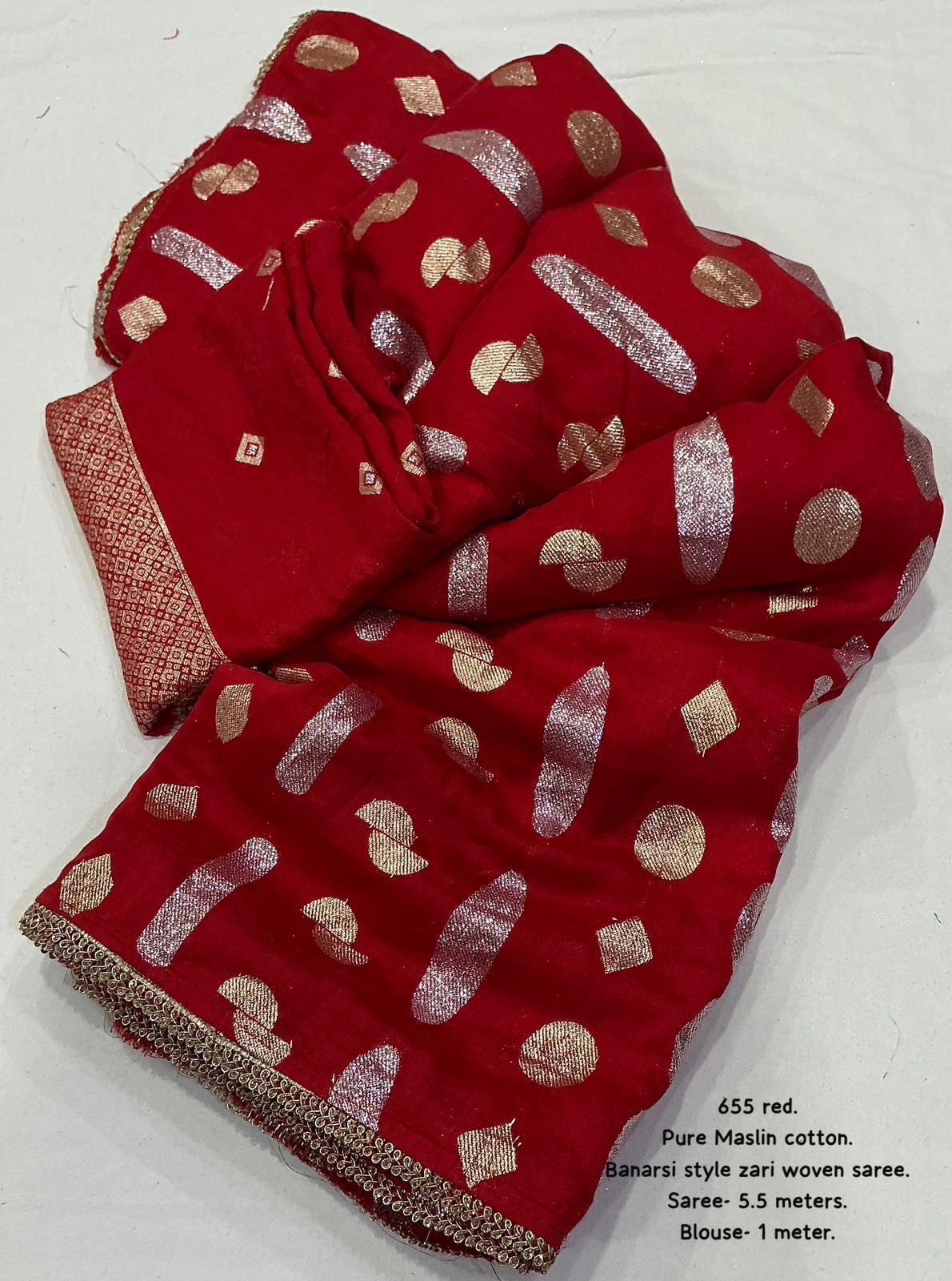 Red saree with gold patterns on a white background
