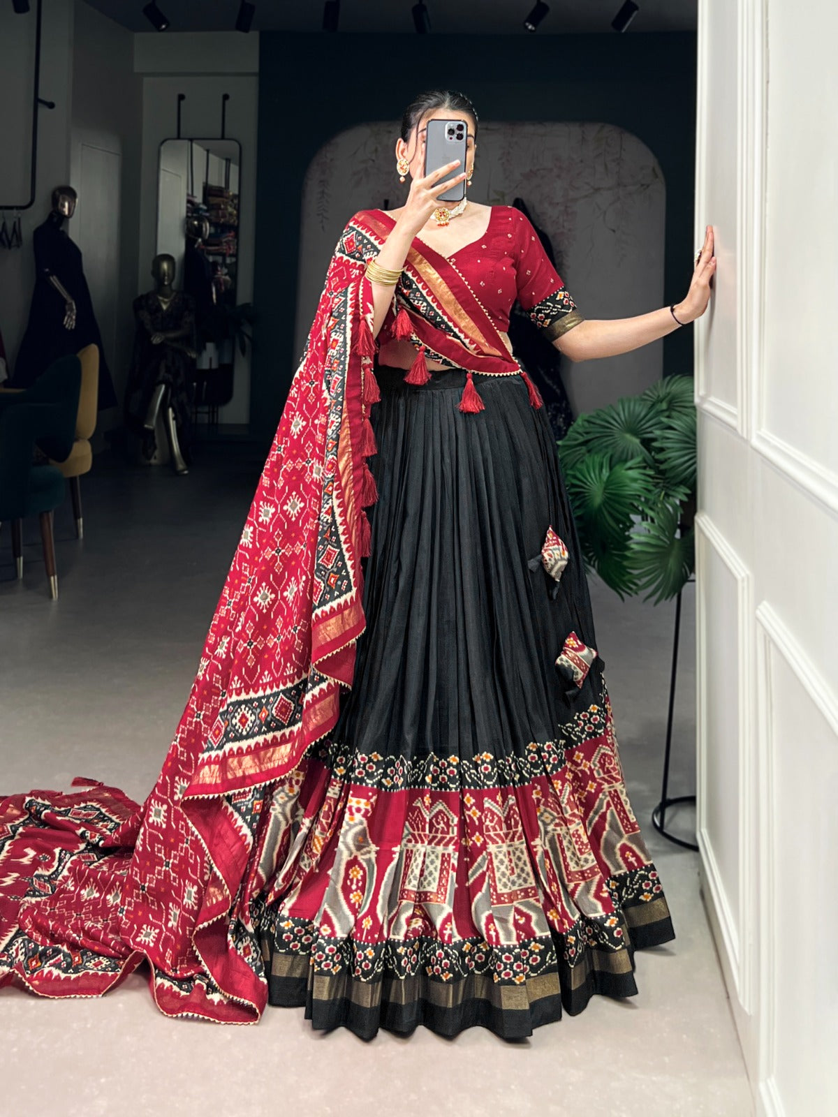 Woman in a traditional black outfit with a patterned dupatta