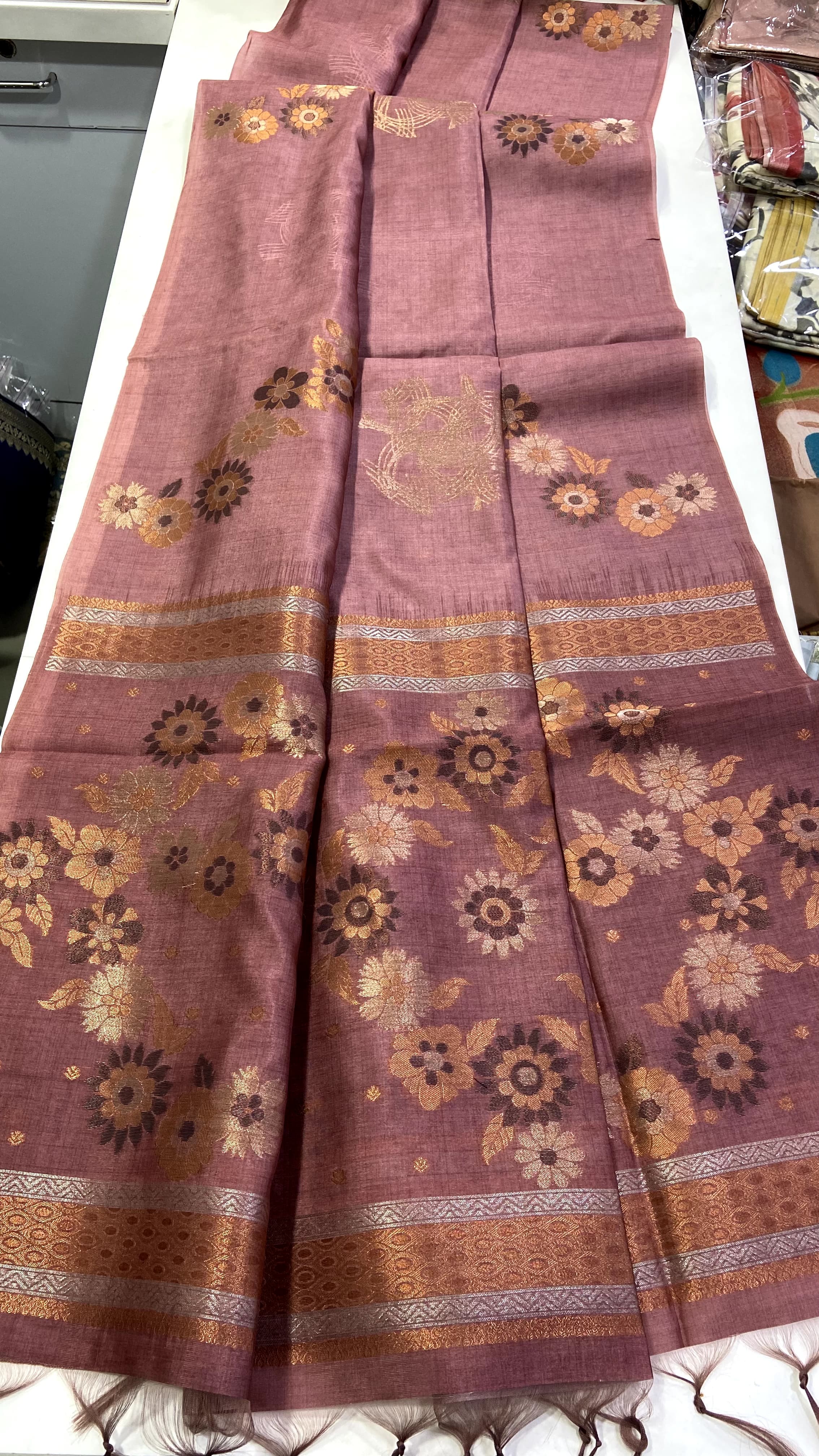Copper fabric with floral patterns on a white surface