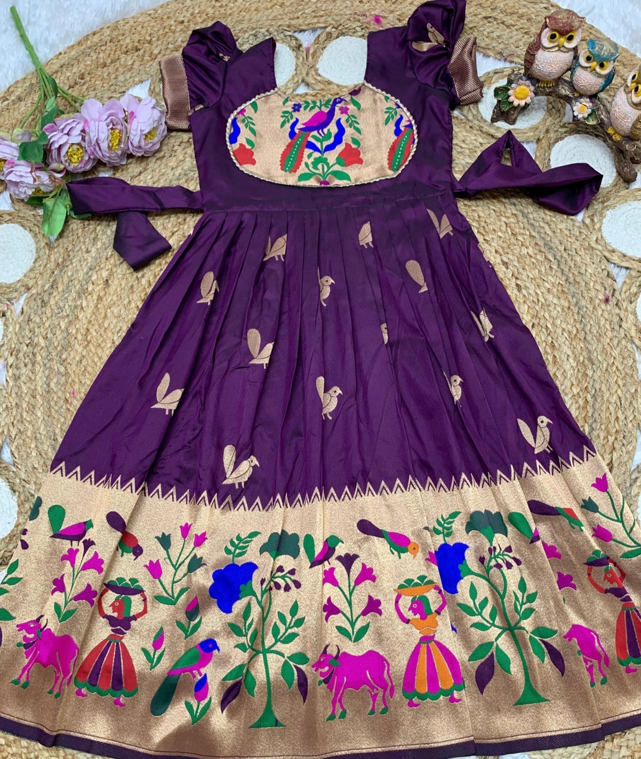 Dark Purple and embroidery dress with floral and animal patterns on a texture surface.