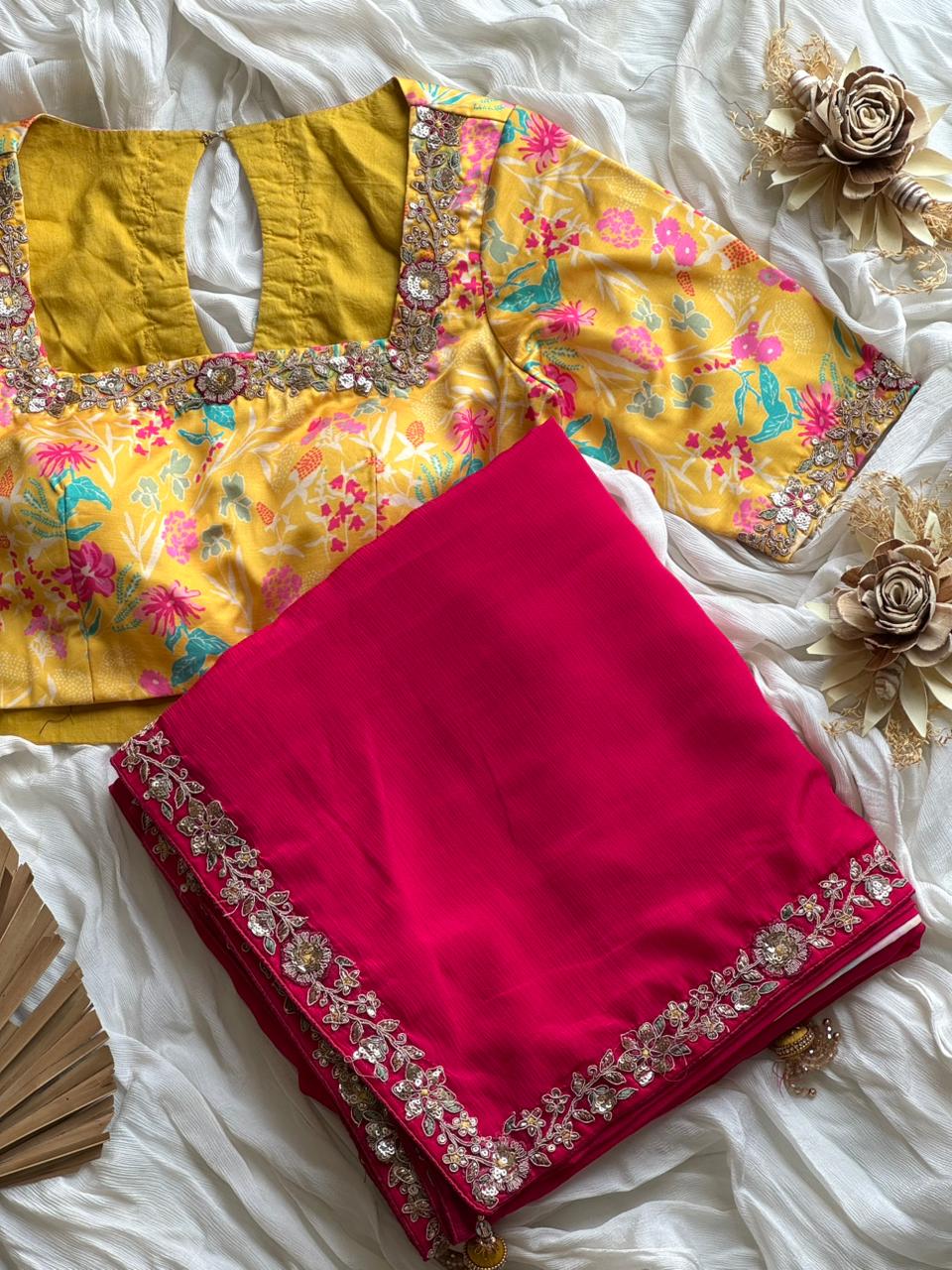 Yellow floral blouse with pink saree on a white fabric background