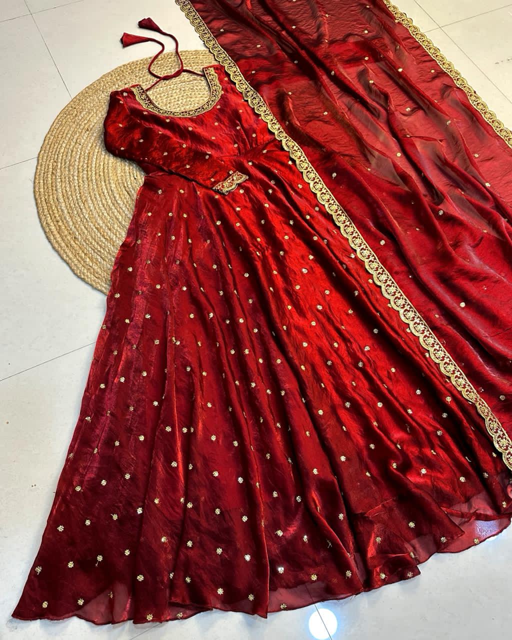 Maroon dress with gold embroidery on a light background