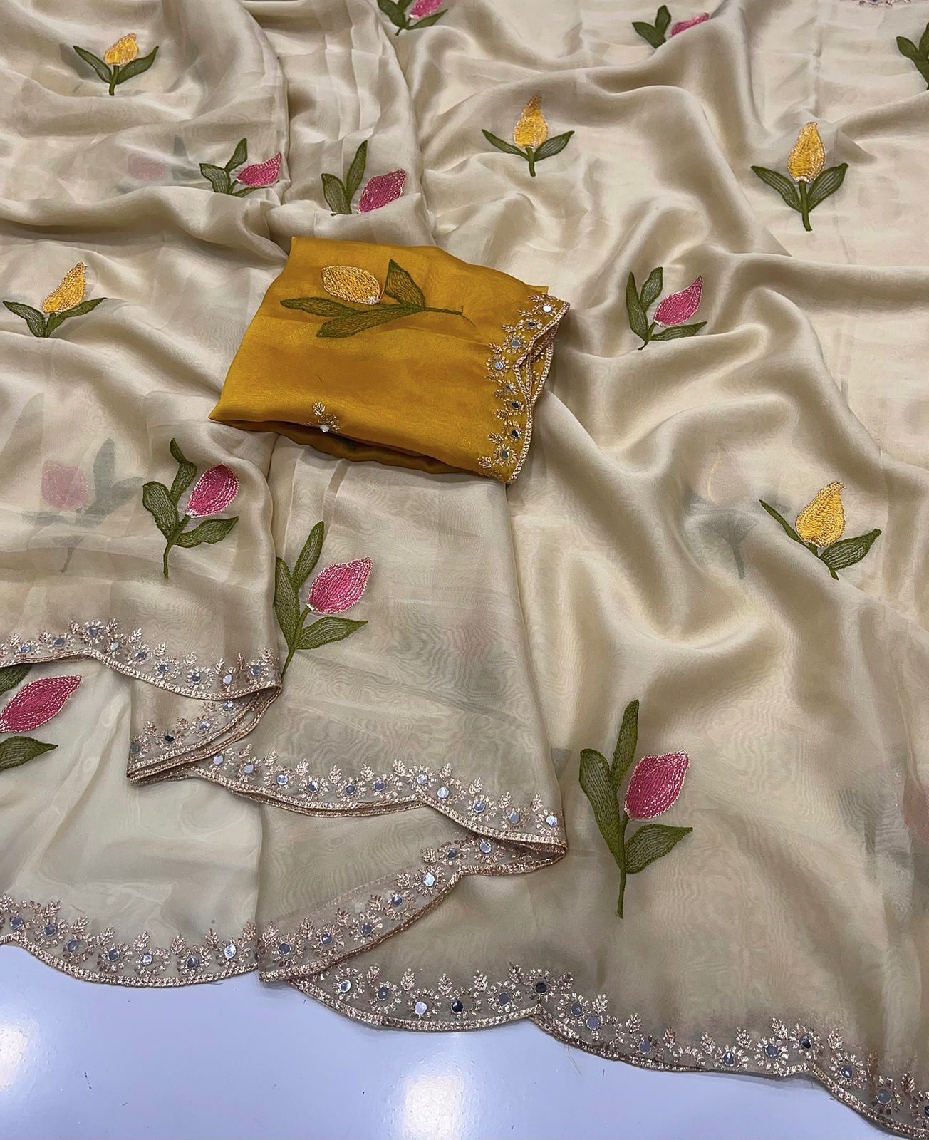 Cream Embroidery saree with a yellow blouse on a light background