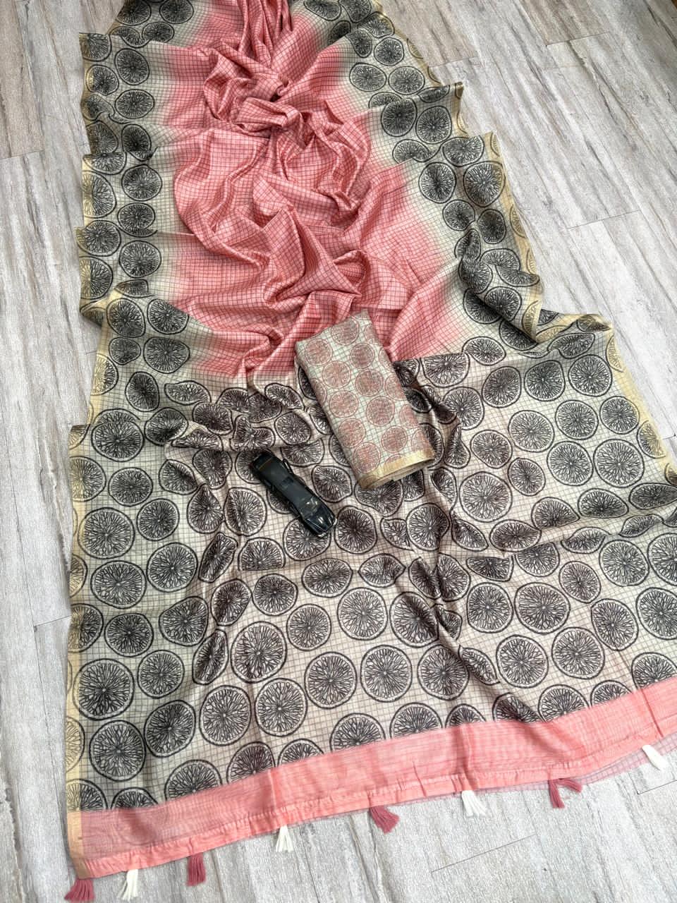 Saree with peach and black patterns on a wooden surface