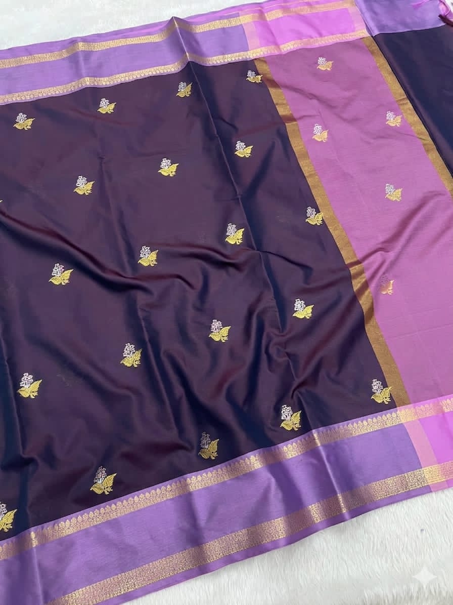 Purple saree with gold border and patterns on a white background