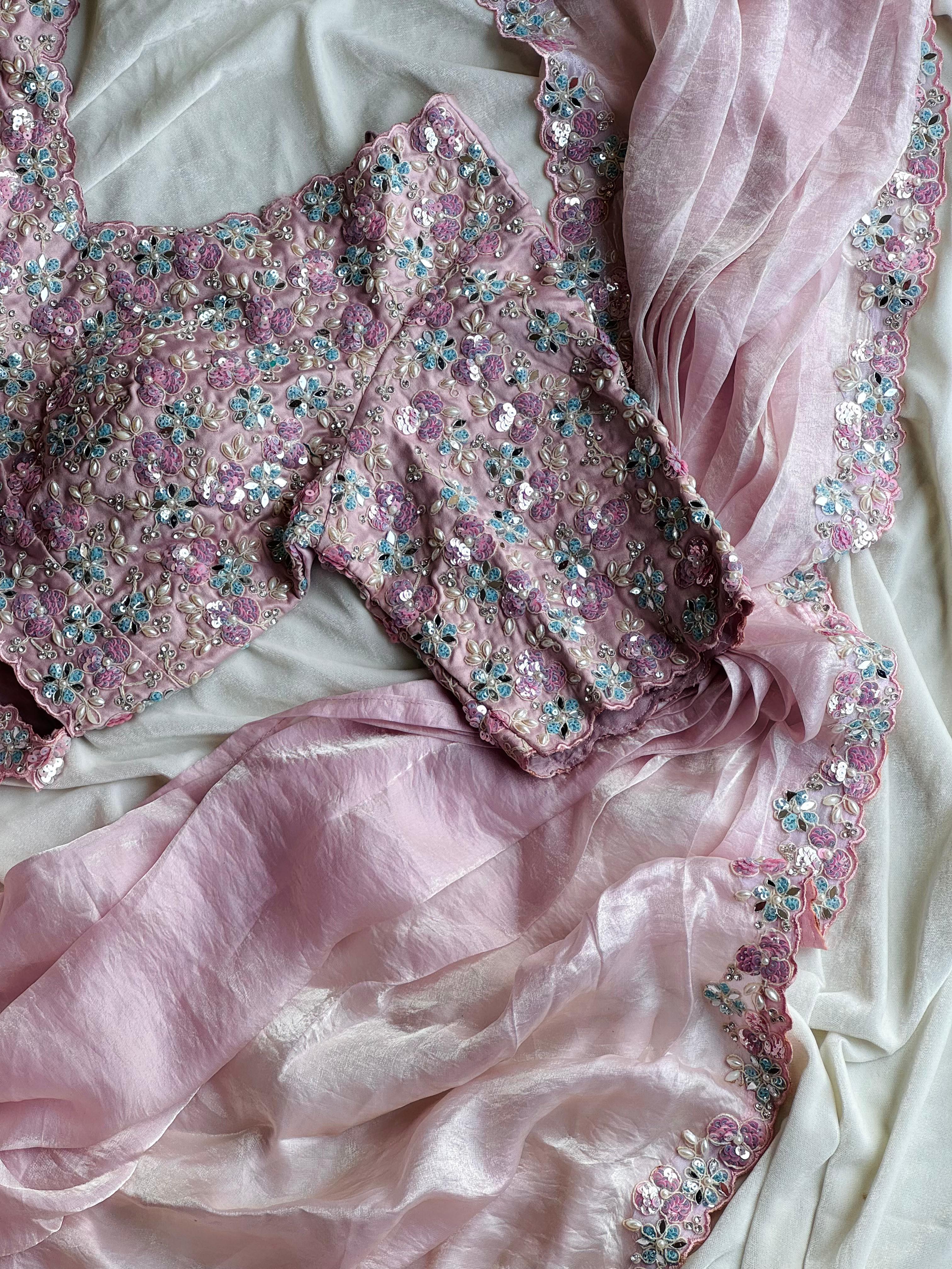 Blush Pink embroidered garment on a white fabric background