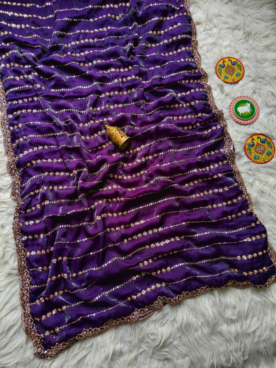 Purple fabric with gold embroidery on  textured surface
