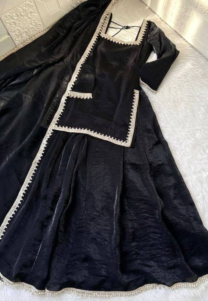 Black dress with w
 trim on a light-color surface
