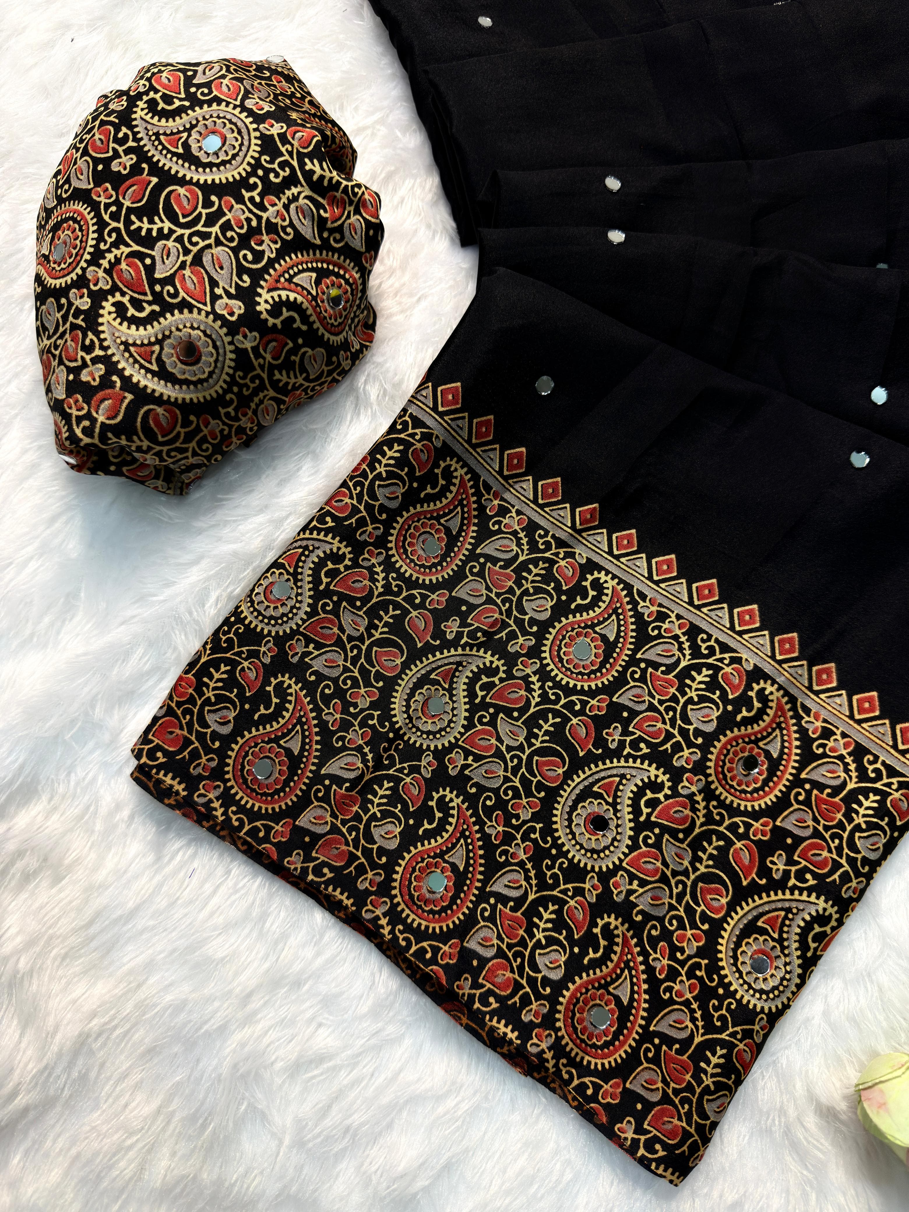 Black fabric with intricate paisley patterns on a white surface
