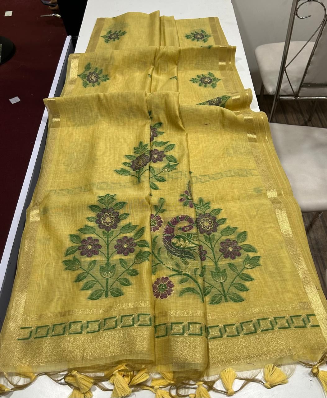 Yellow fabric with  floral patterns on a white surface