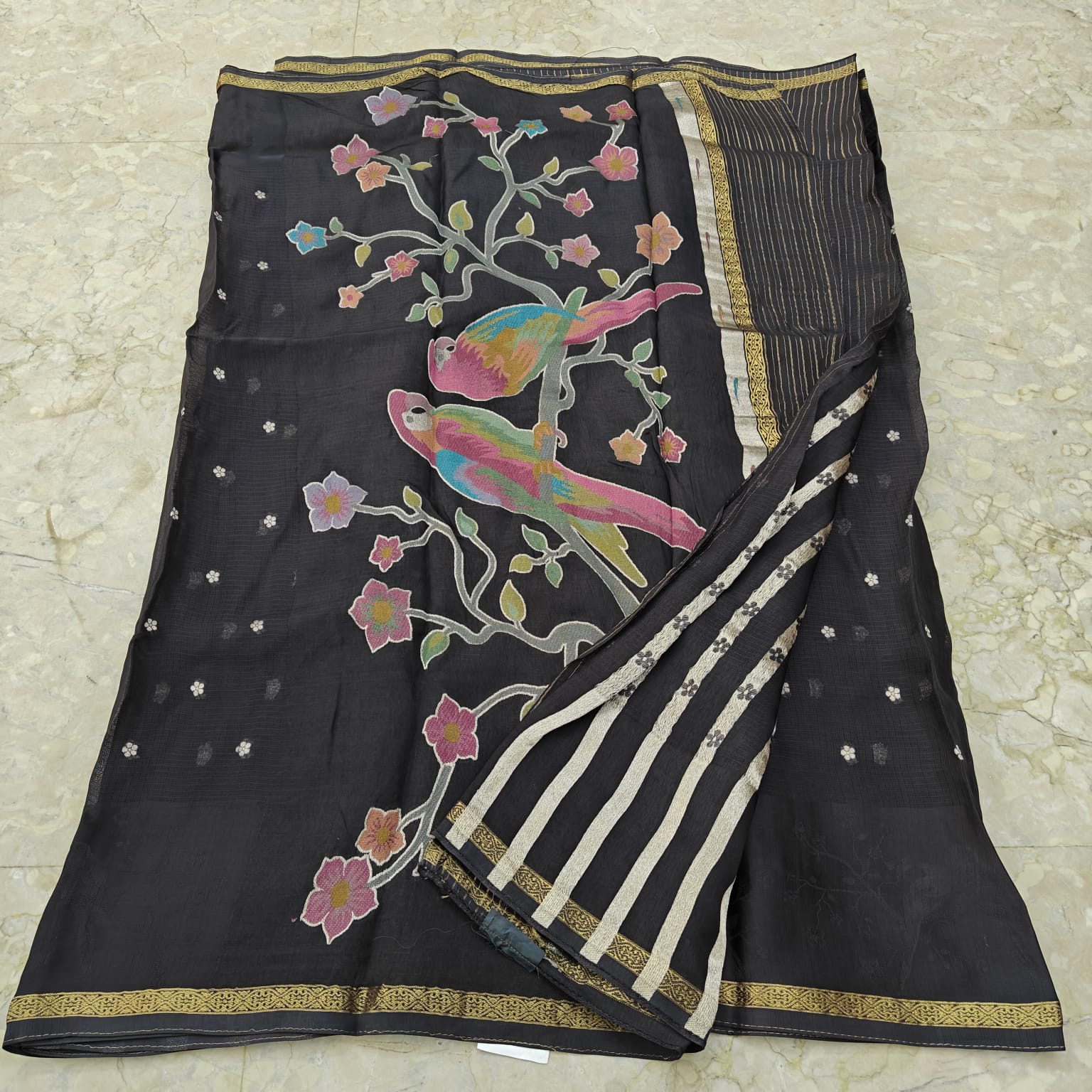 Black saree with colorful bird and floral patterns 