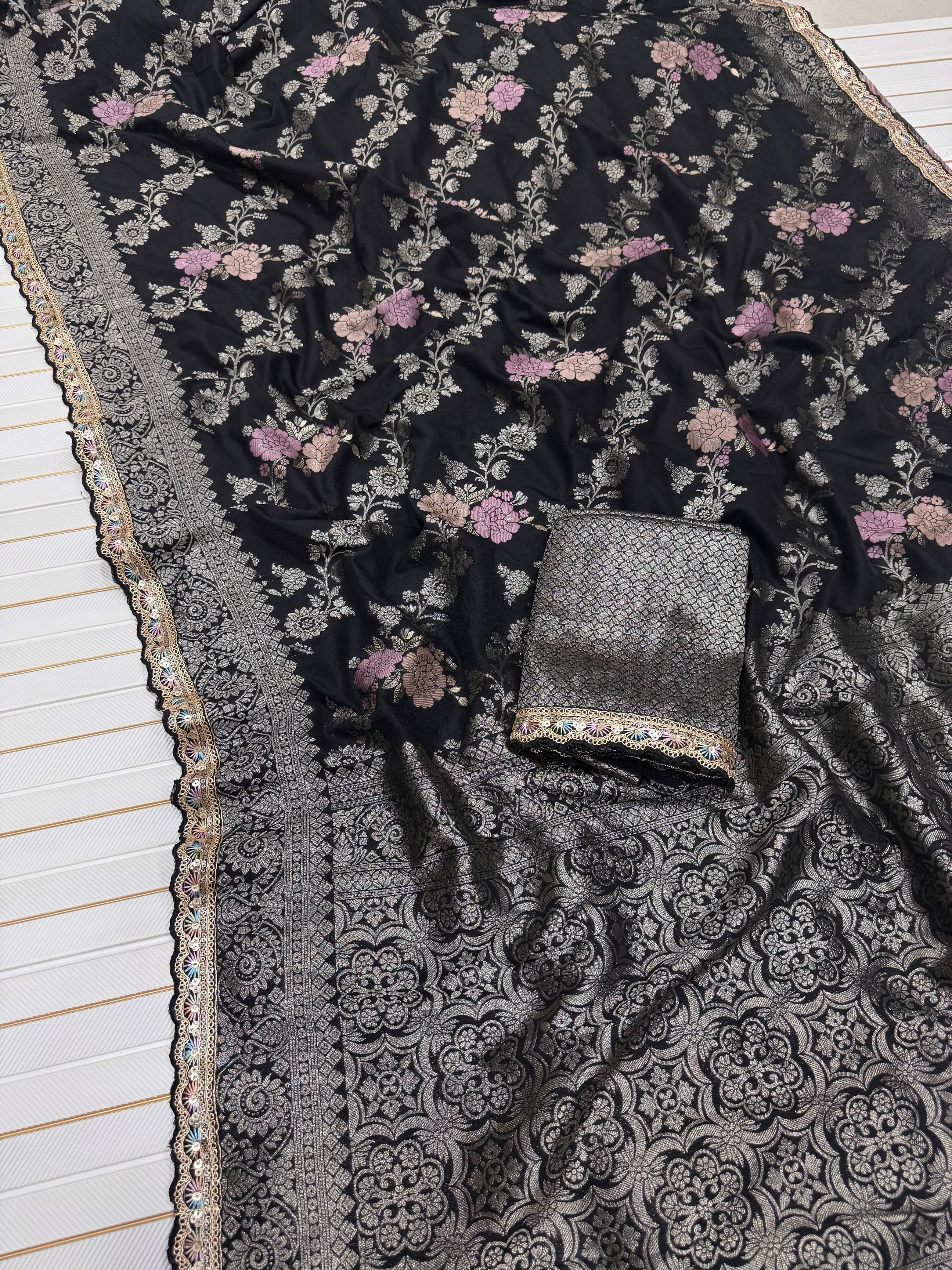Black floral patterned fabric with a decorative border on a white background